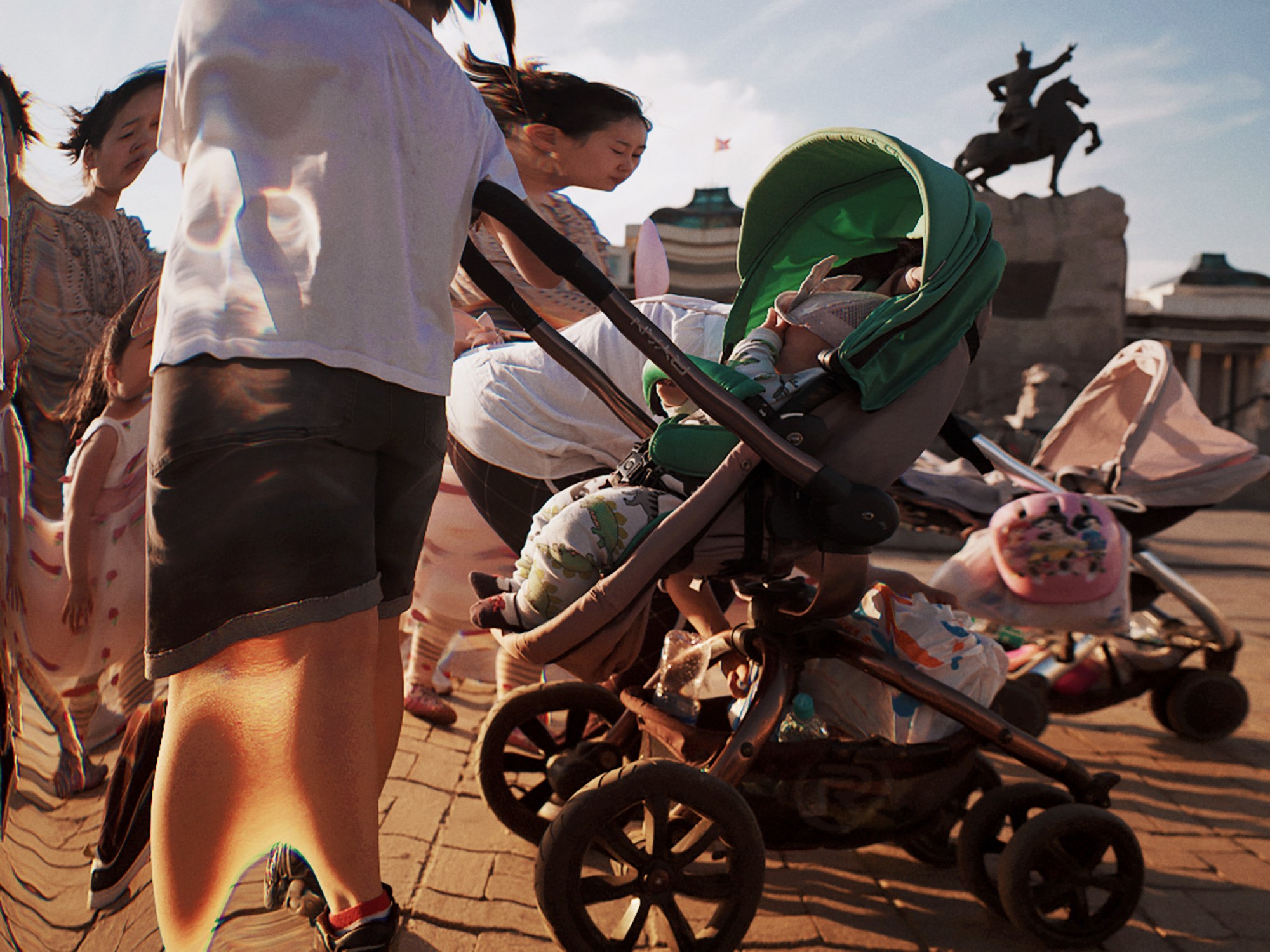 mongolian women push their children in prams through a city square; the photo is warped in an AI style