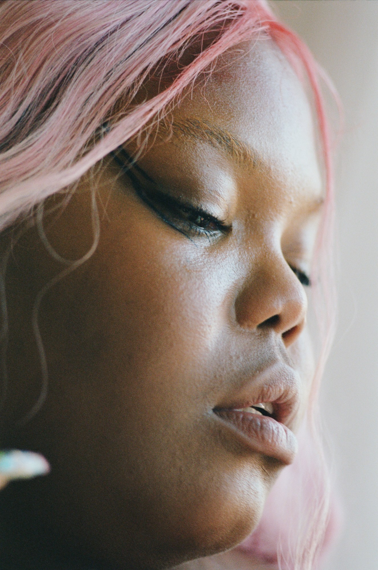 a woman in a pink wig posing for a portrait