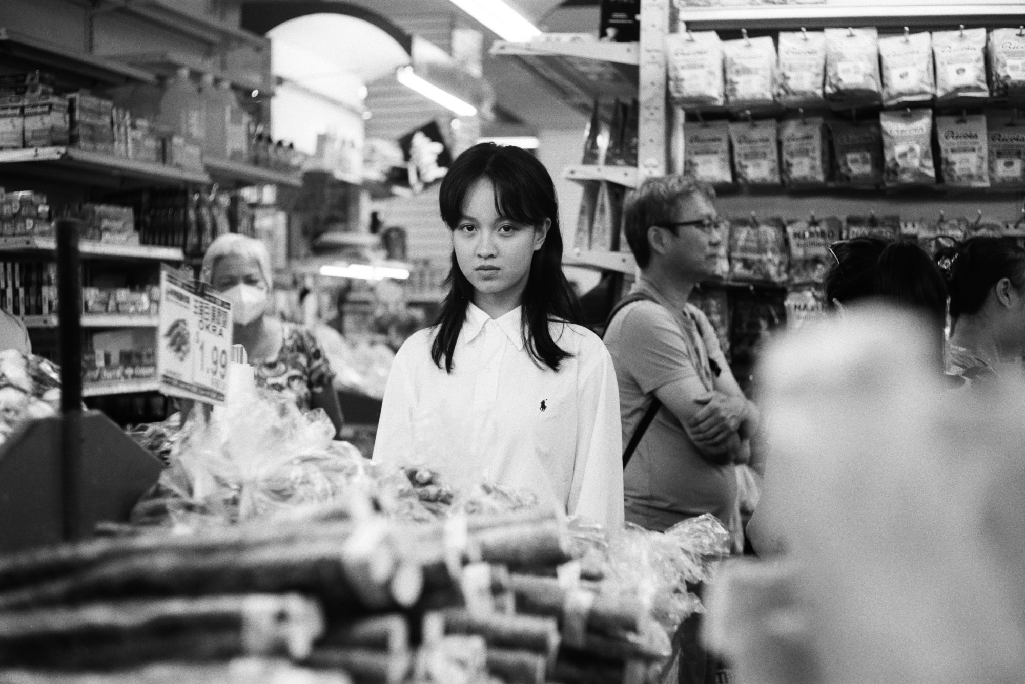 lucie zhang posing in the crowd at a chinatown market