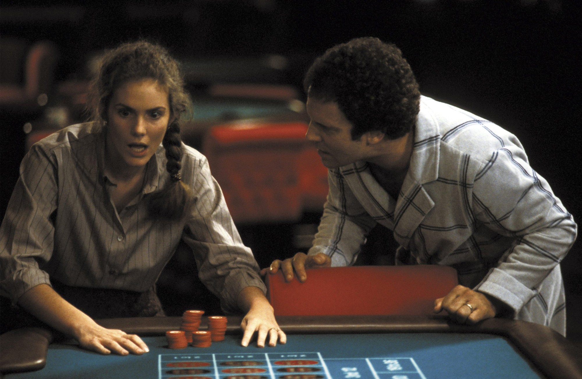 a couple stand over a poker table in the film Lost in America (1985)