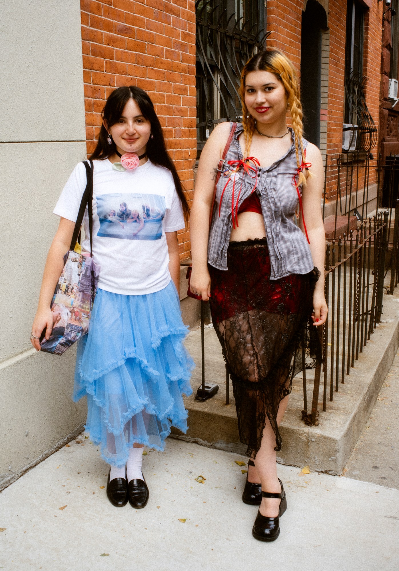 ashley markle photo of a sofia coppola fan on the streets of new york/ one wears a virgin suicides t-shirt and a billowy blueskirt, the other is wearing a lace-heavy outfit with a 90s sports-style waistcoat.