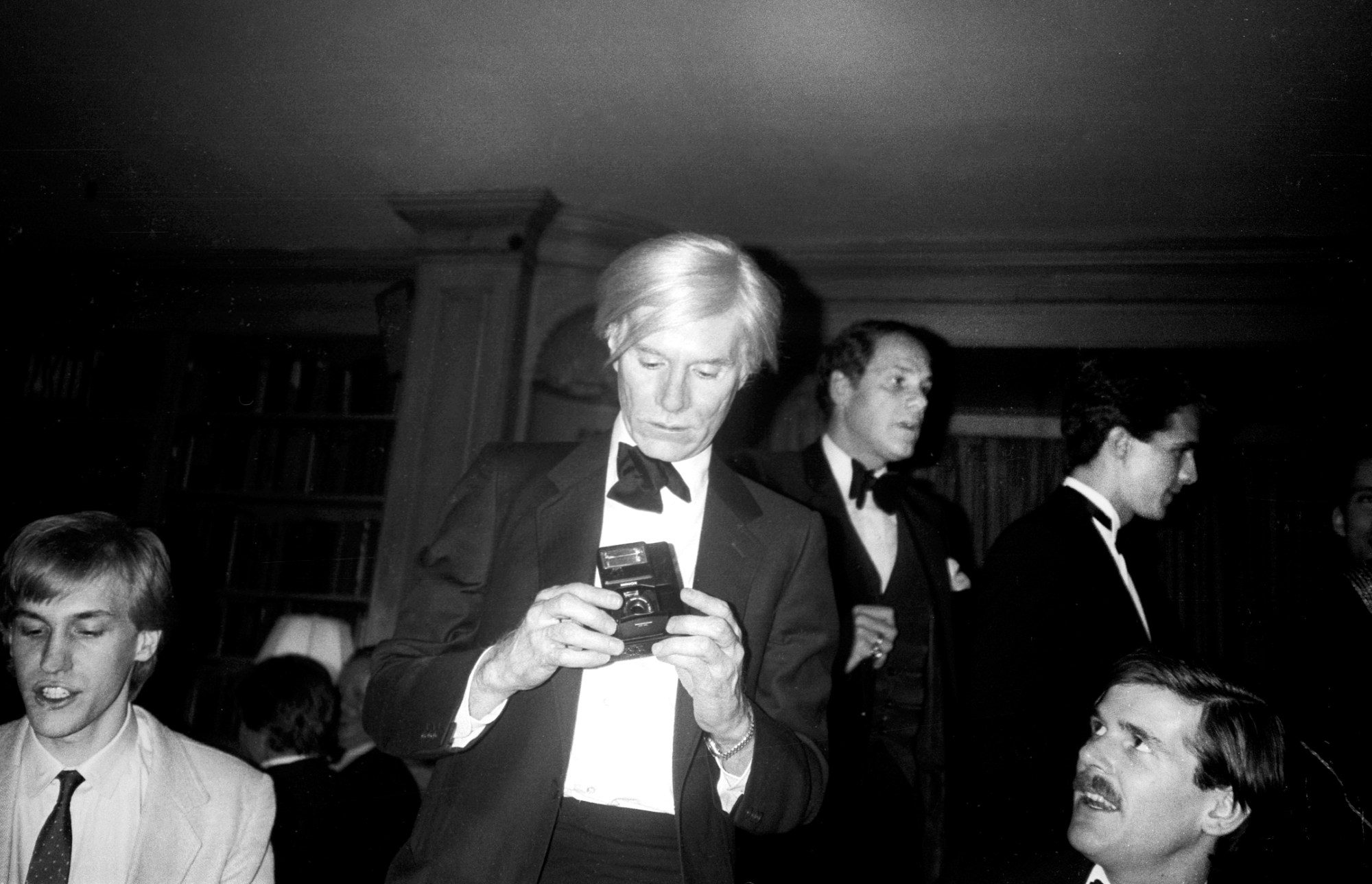 patrick mcmullan photo of andy warhol in a tuxedo preparing to take a photo