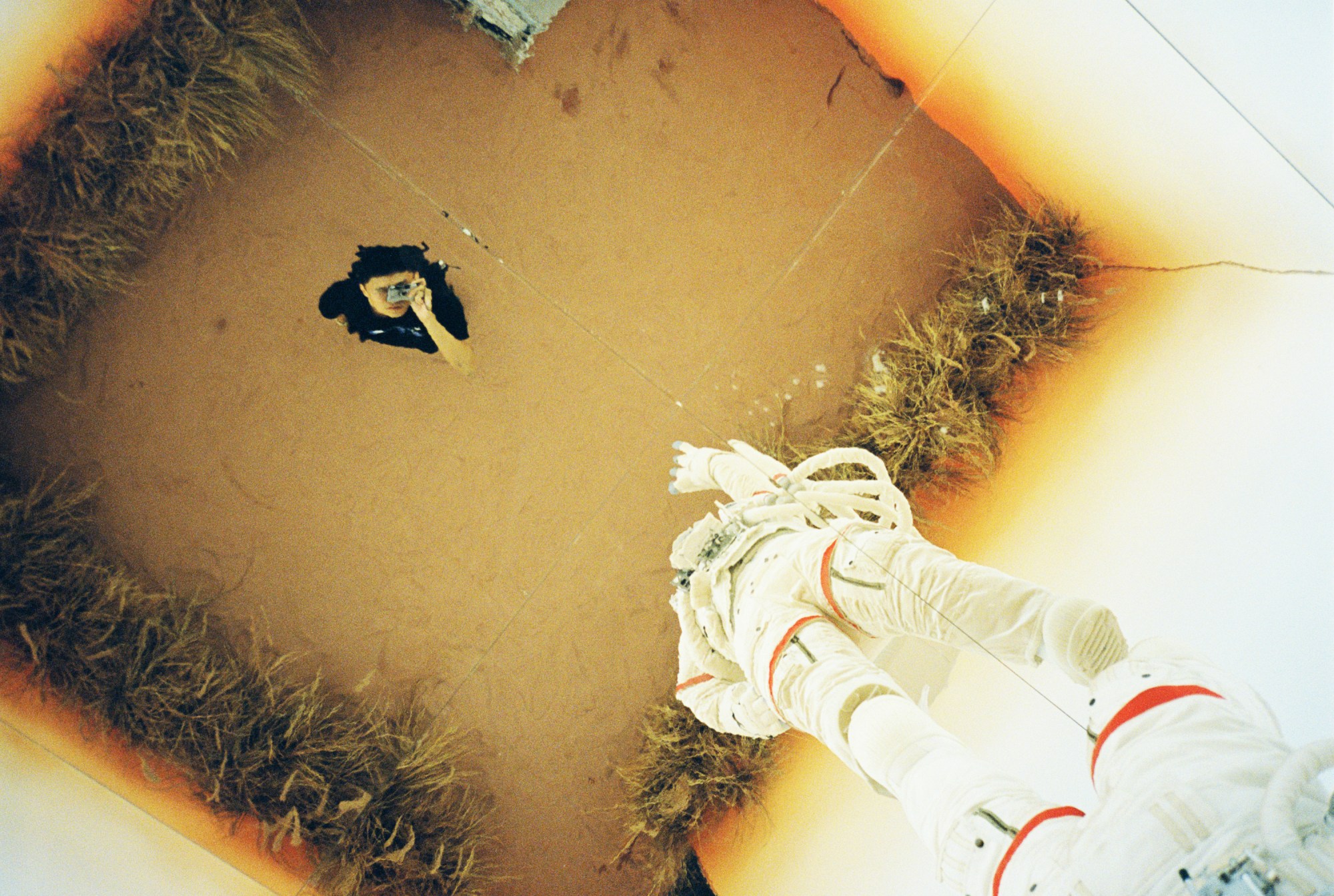 a photographer taking a photo of an astronaut suit