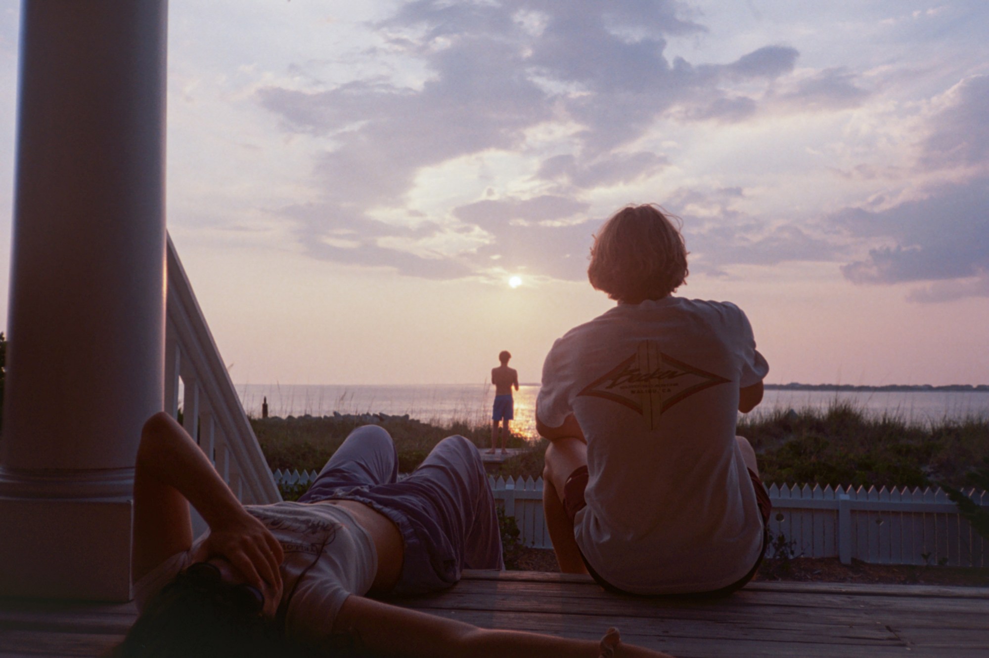 three teens looking out on the ocean