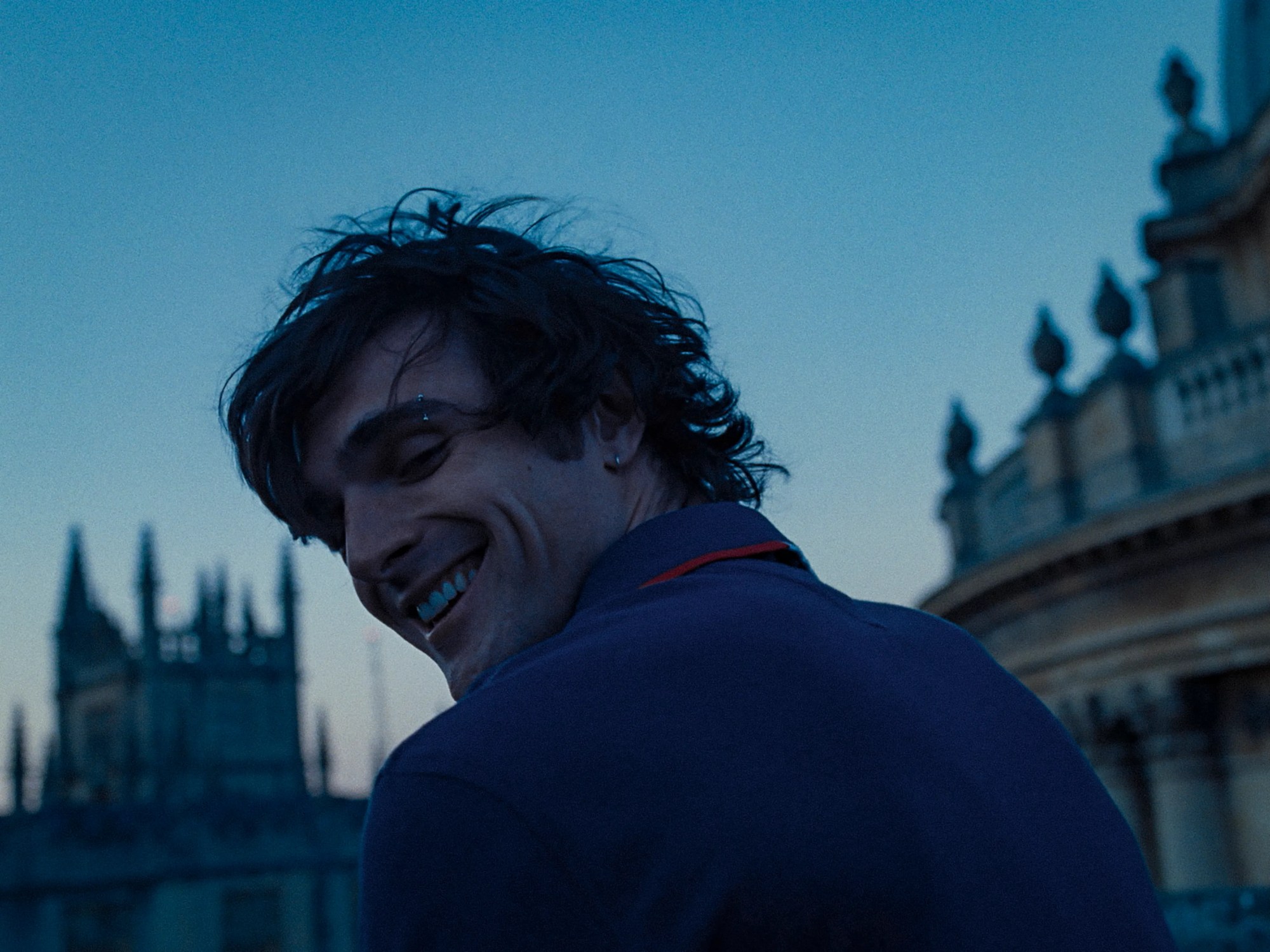 jacob elordi smiling with an eyebrow piercing in saltburn by emerald fennell