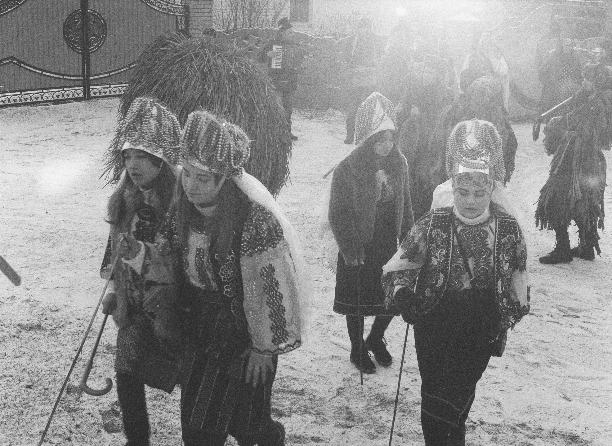 a group of young girls wearing traditional costumes gather in a rural street in ukraine for a parade