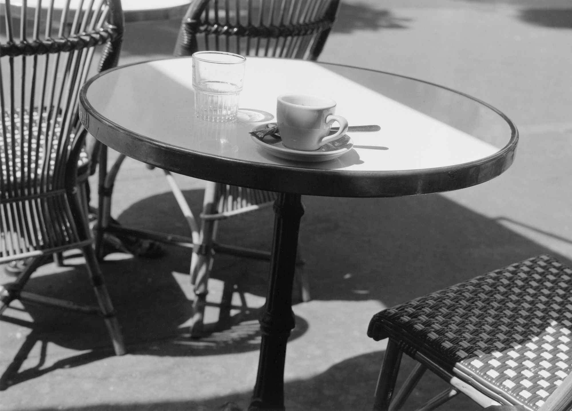 a cafe table with an empty espresso cup