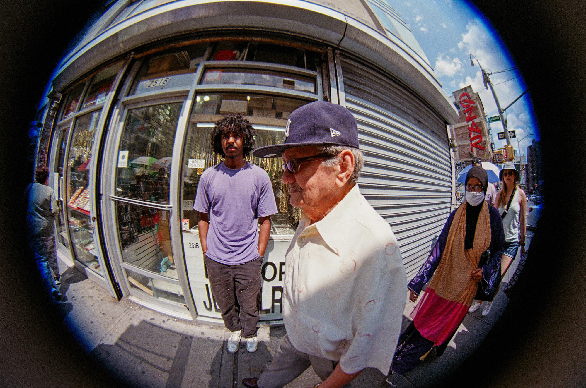 leeban standing in front of a jewlery store in chinatown shot with fish eye by jacob consenstein