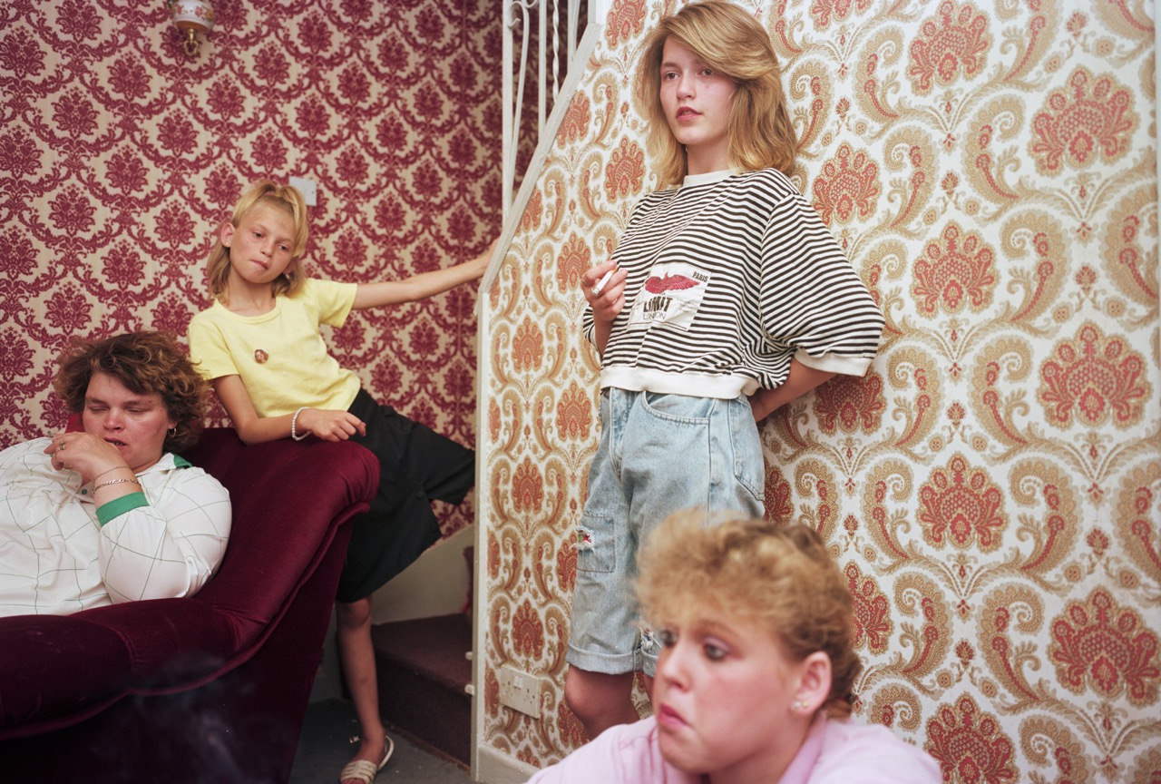 Photograph by Nick Waplington of a mother and her three daughters in their living room from The Living Room series.