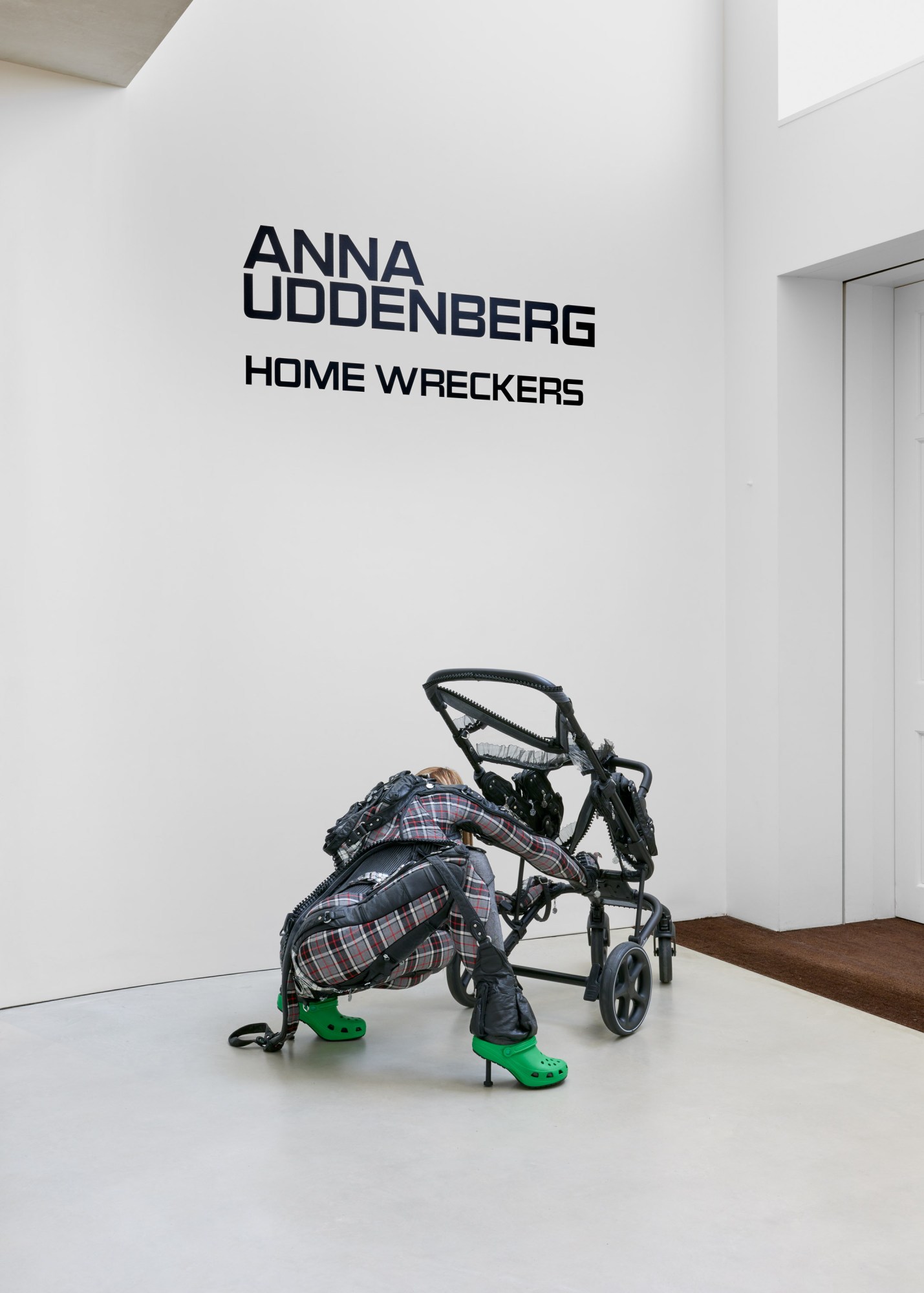 Sculpture by Anna Uddenberg in her 'home wreckers' exhibition at The Perimeter of a woman in croc stilettos bending over a buggy