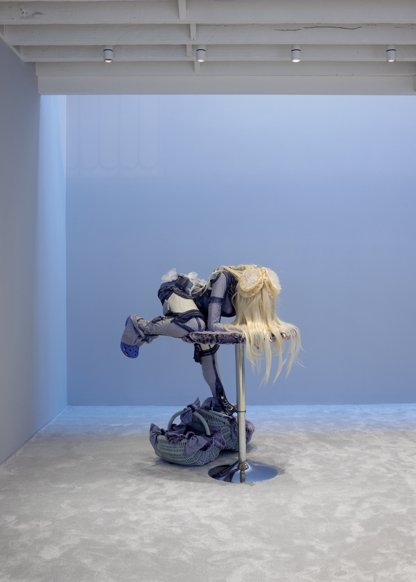 Sculpture by Anna Uddenberg in her 'home wreckers' exhibition at The Perimeter of a woman in crocs climbing onto a table