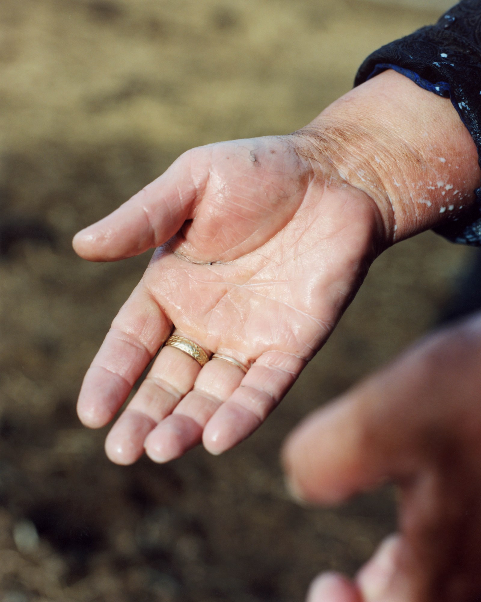 a wet outstretched hang wearing a gold ring