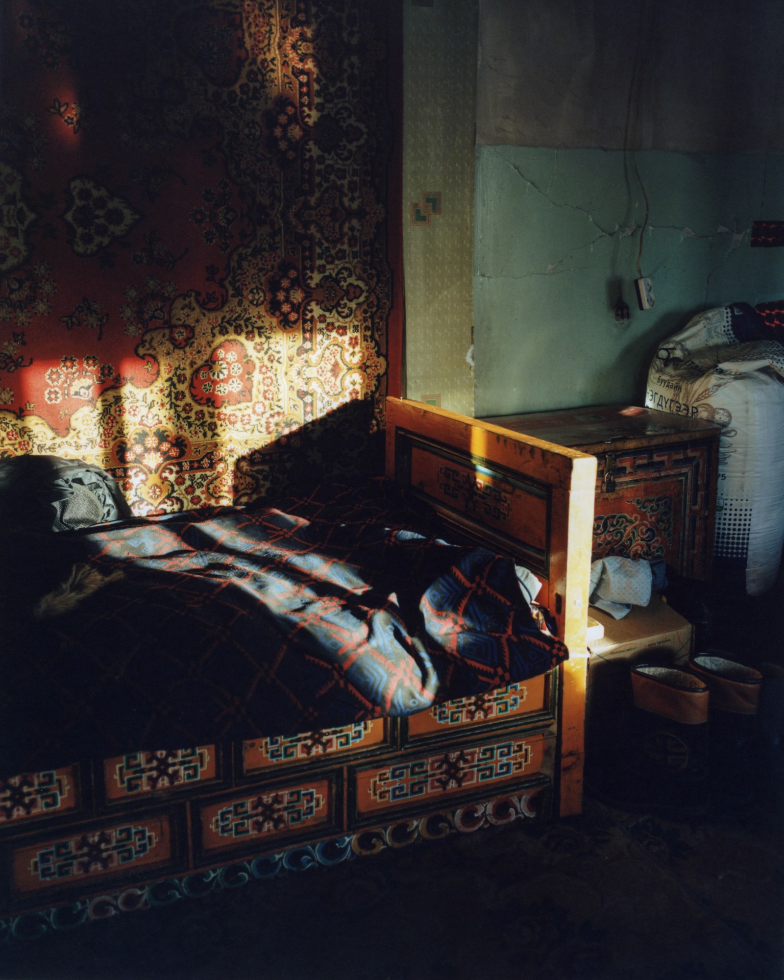 an empty bed covered in navy patterned sheets