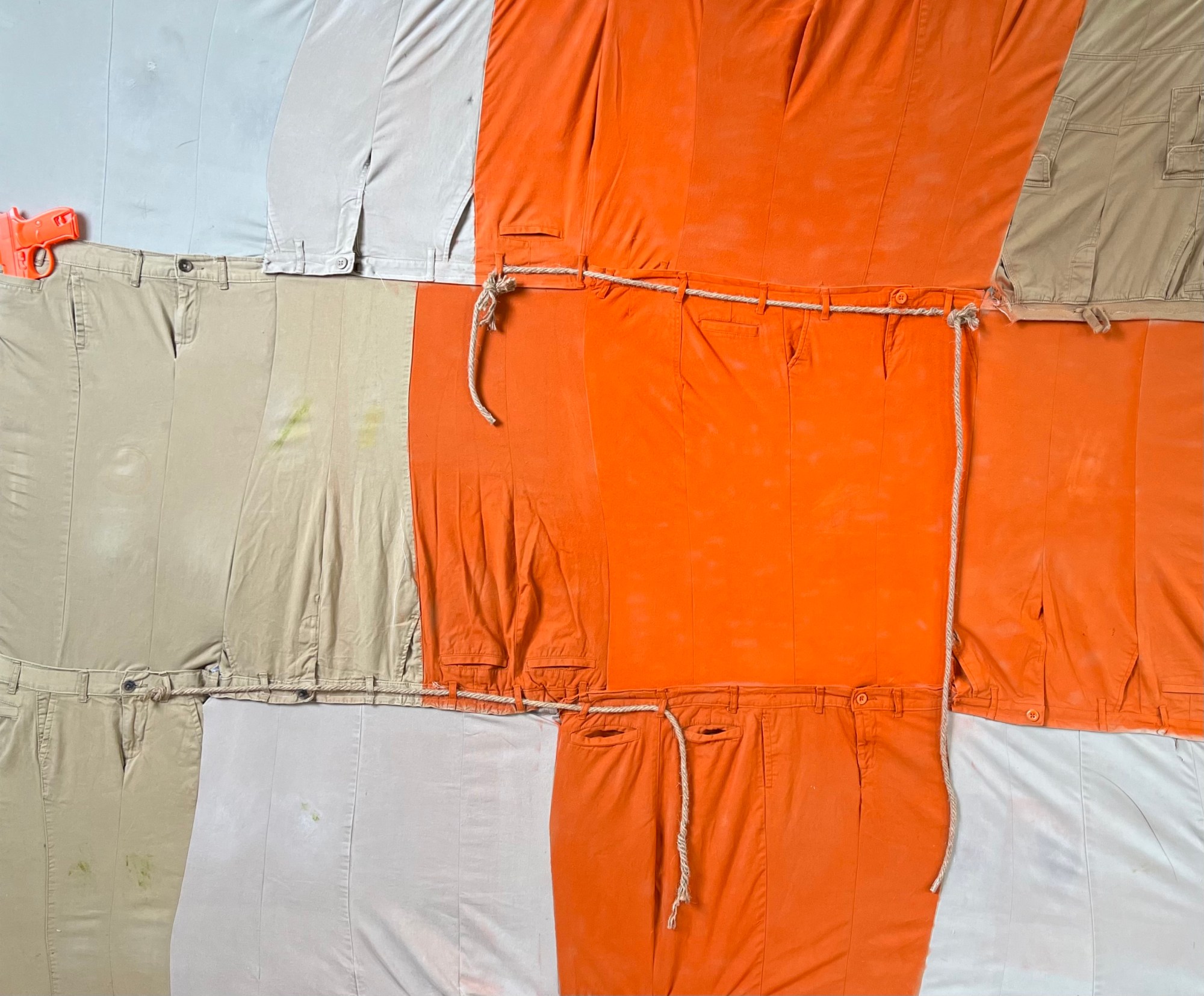 orange prison uniforms stiched together with white and khaki school uniforms