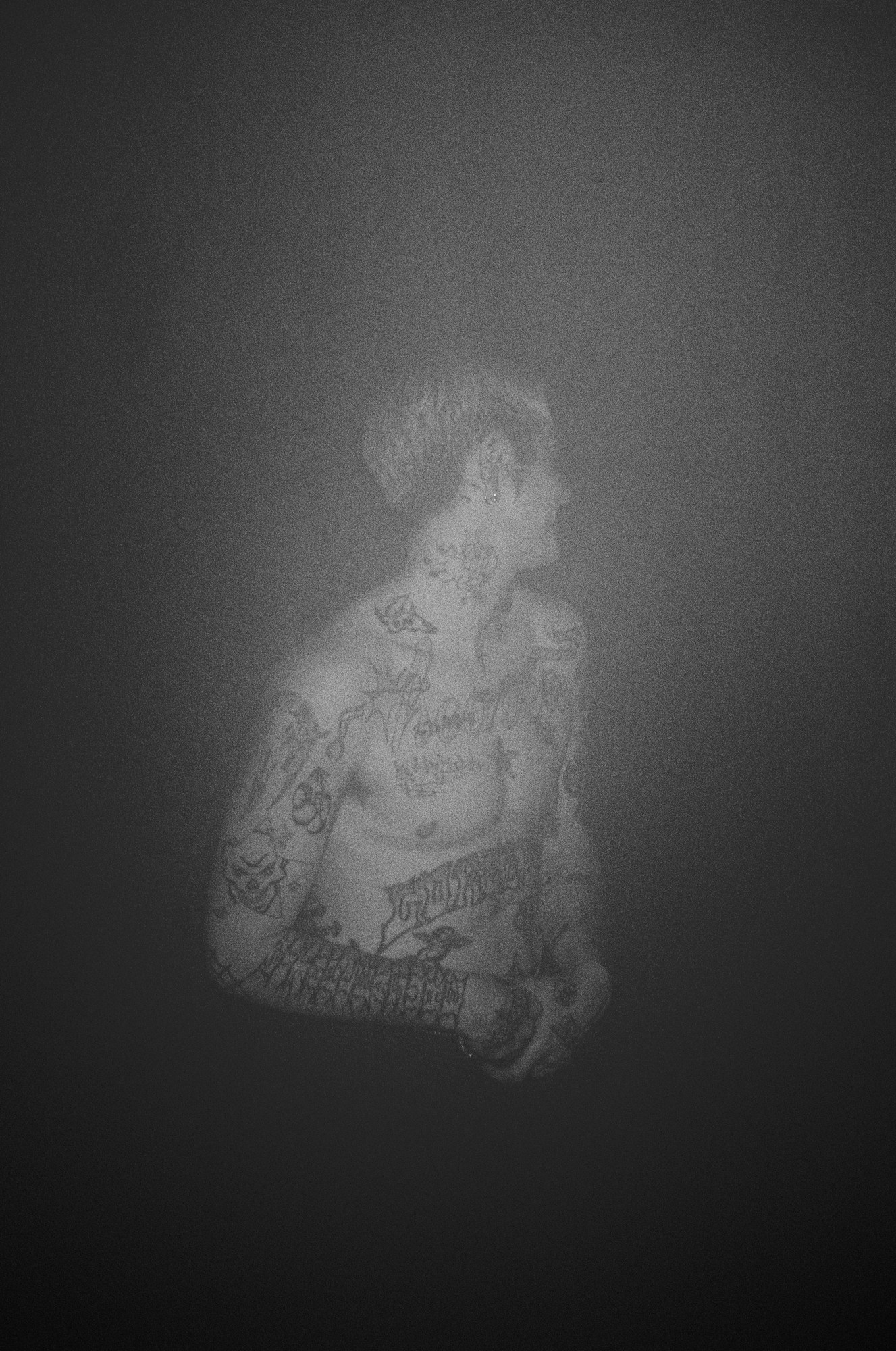 a man covered in tattoos dancing at HOWL in london by rene matic