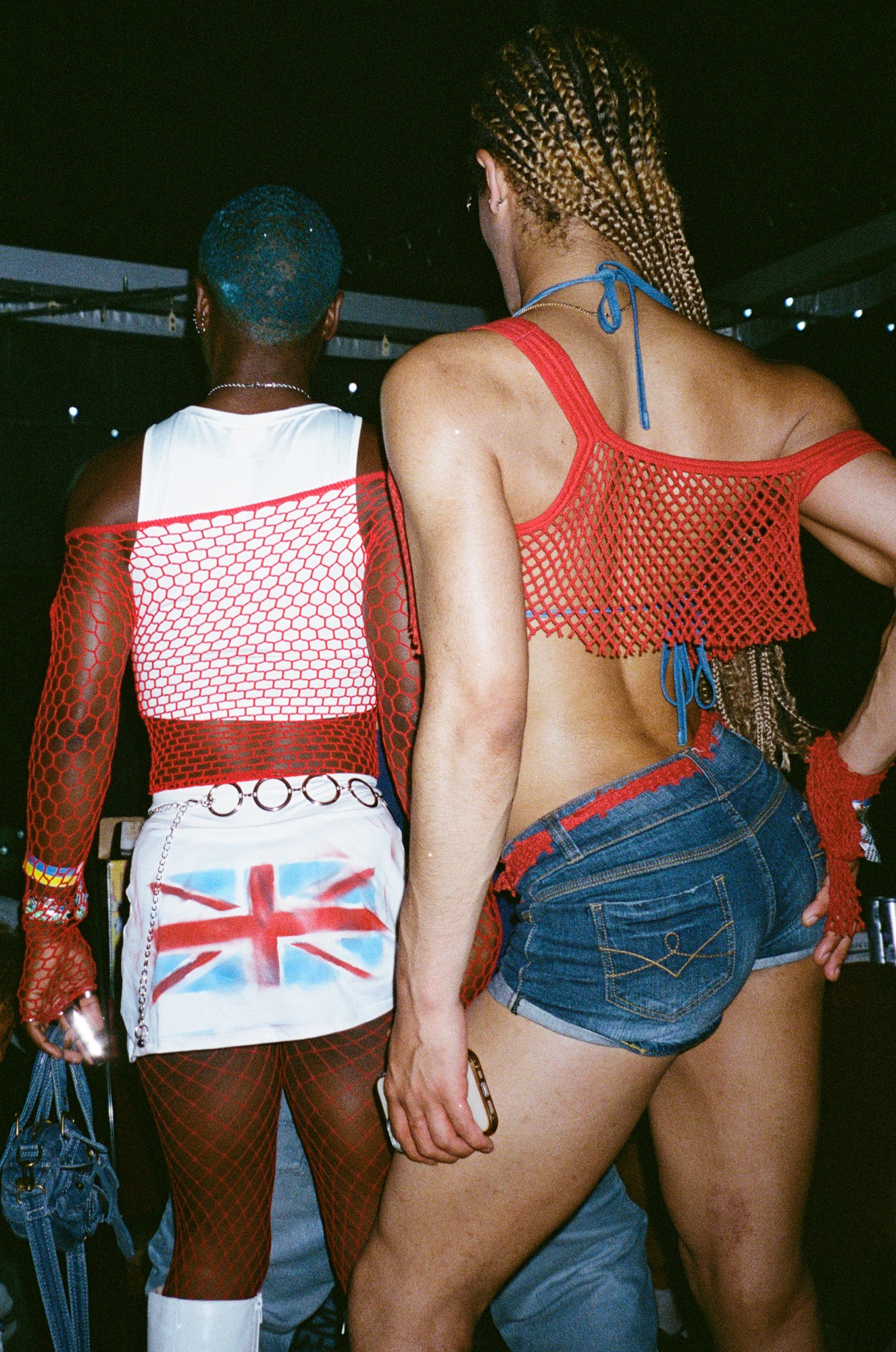 two folks in red fishnet and a painted union jack at glastonbury