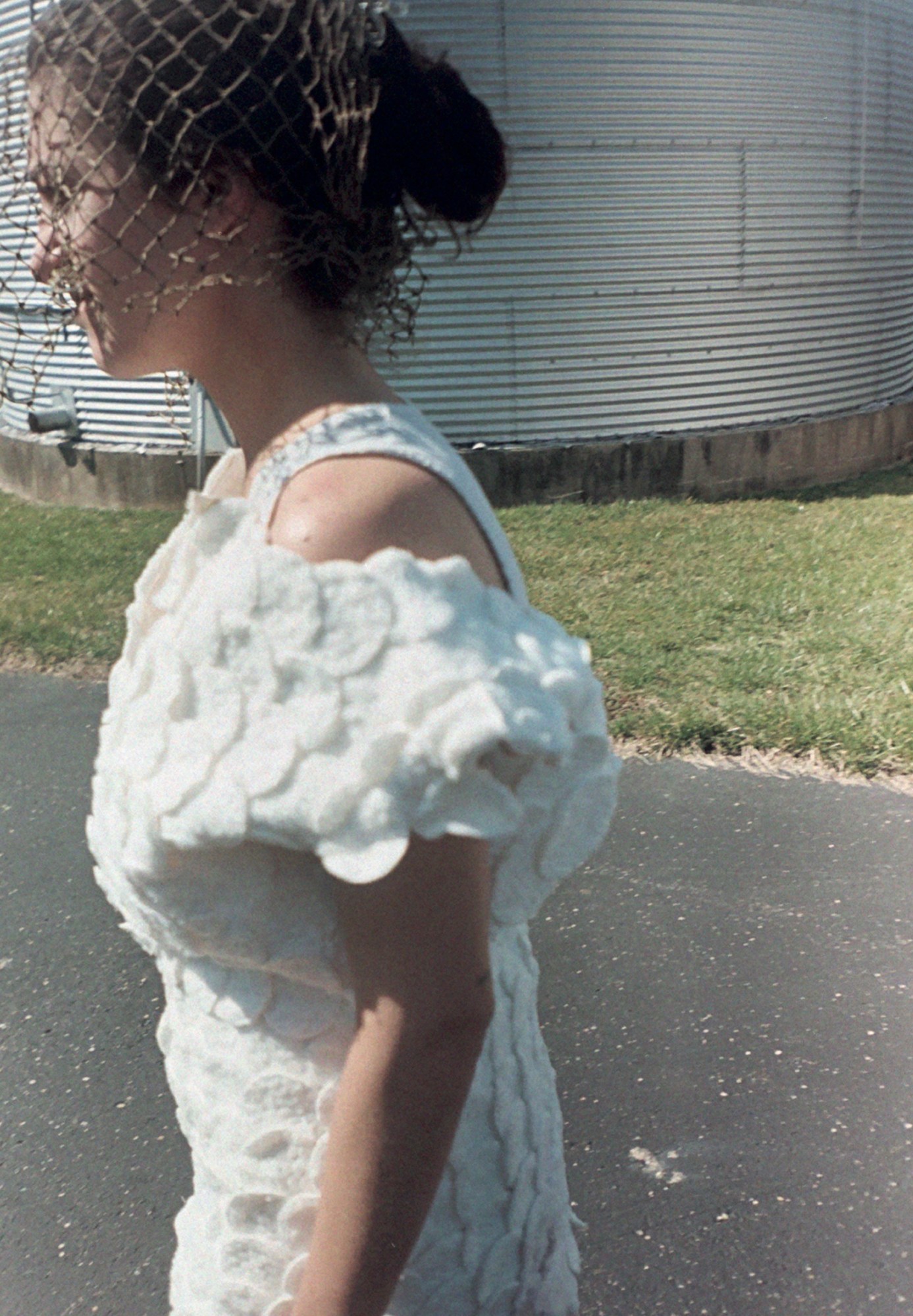 a shayna arnold dress photographed in front of a factory in the midwest