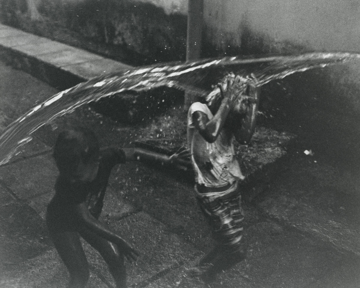 two young children being splashed with water