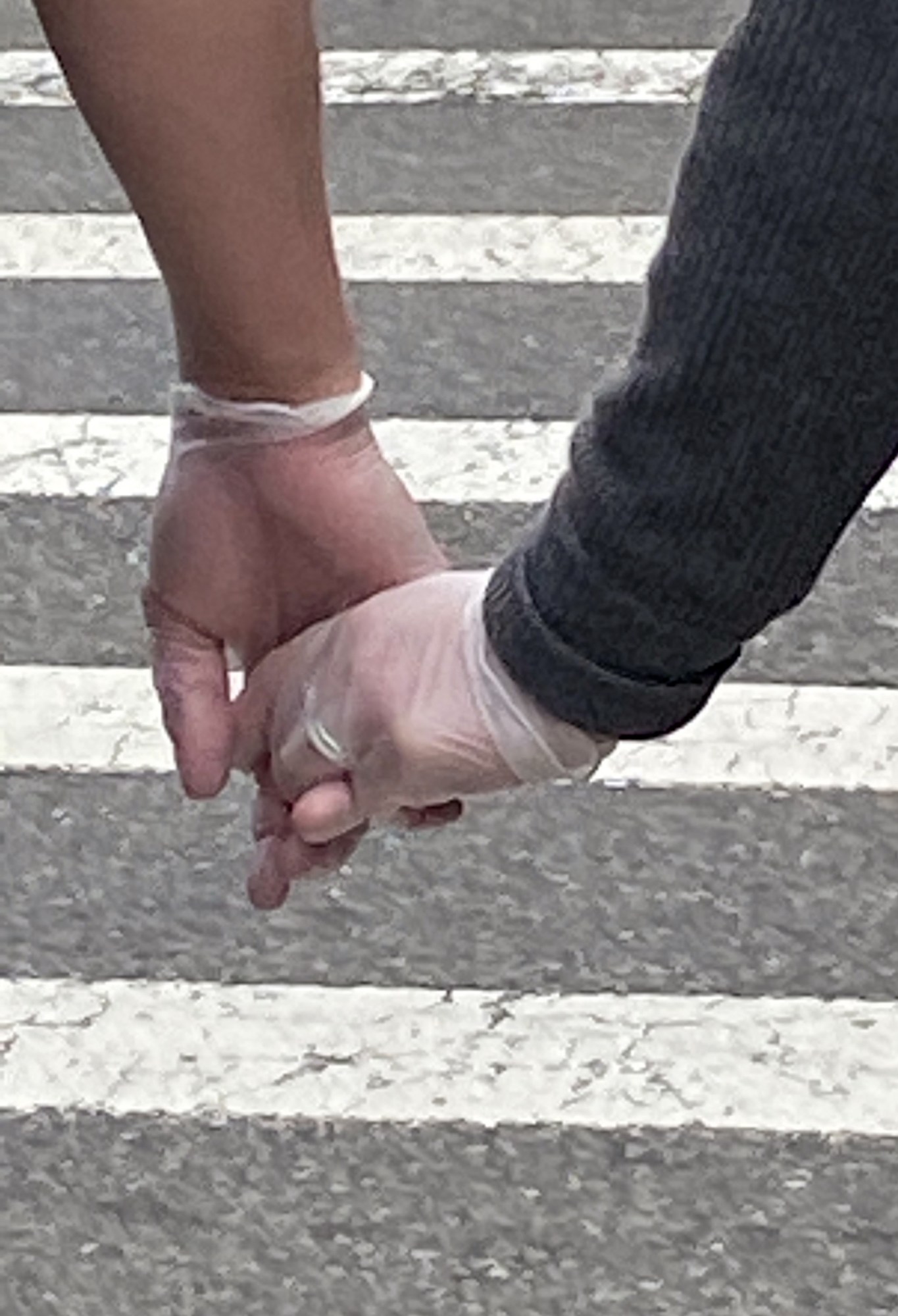 two gloved hands holding onto each other