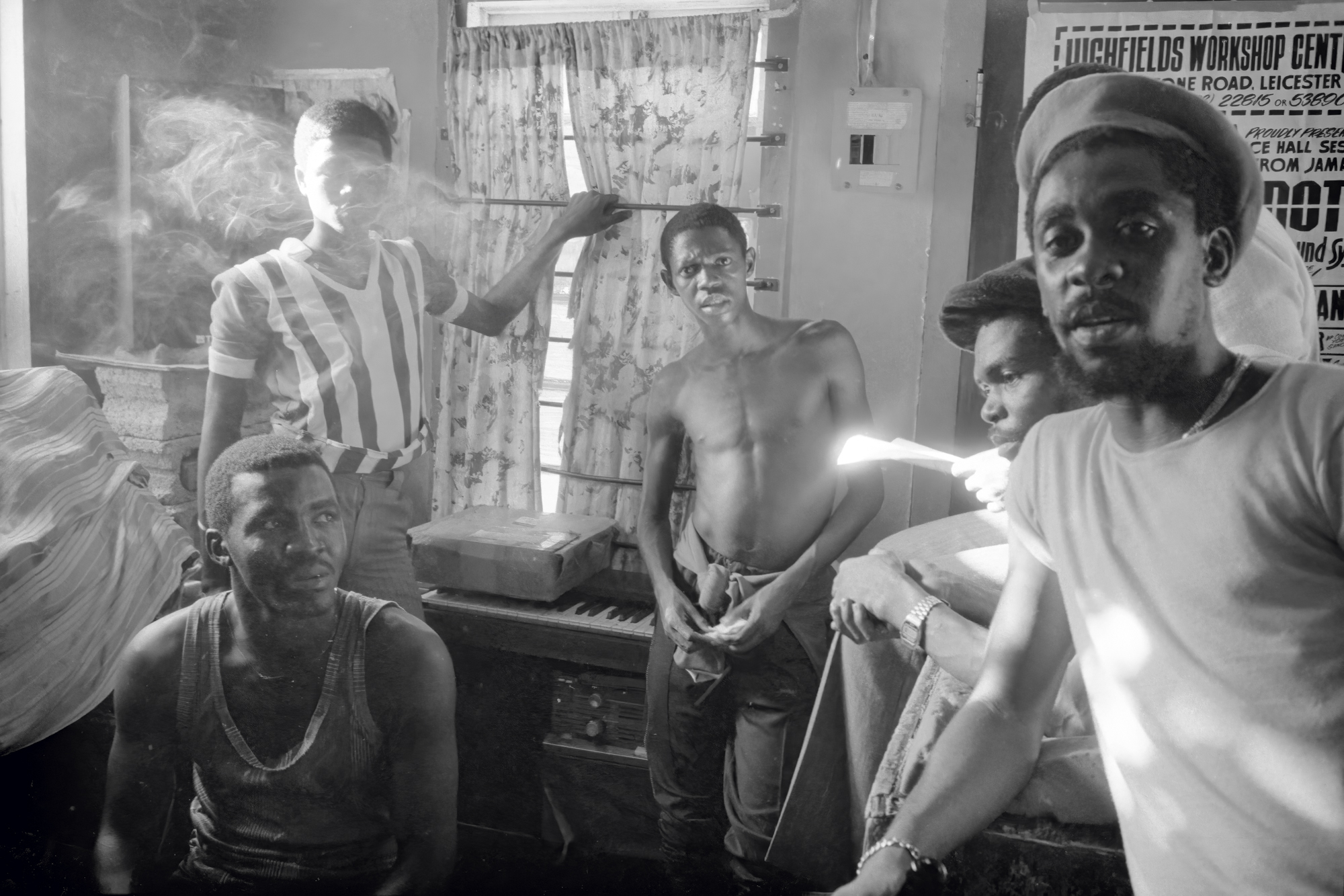 a group of men in a candid photo taken in a smoke filled room