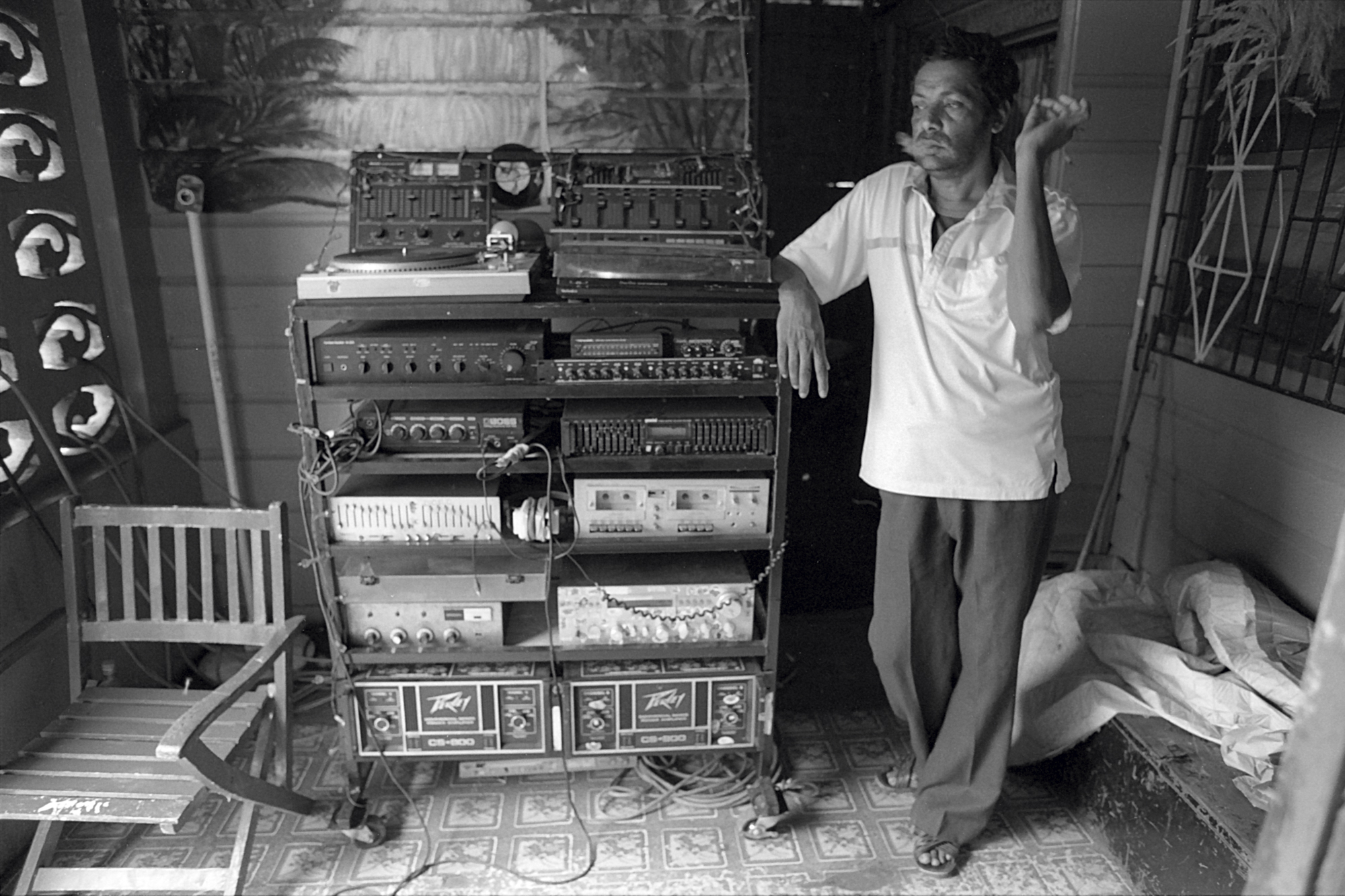 a man standing next to a cart filled with speaker equipment