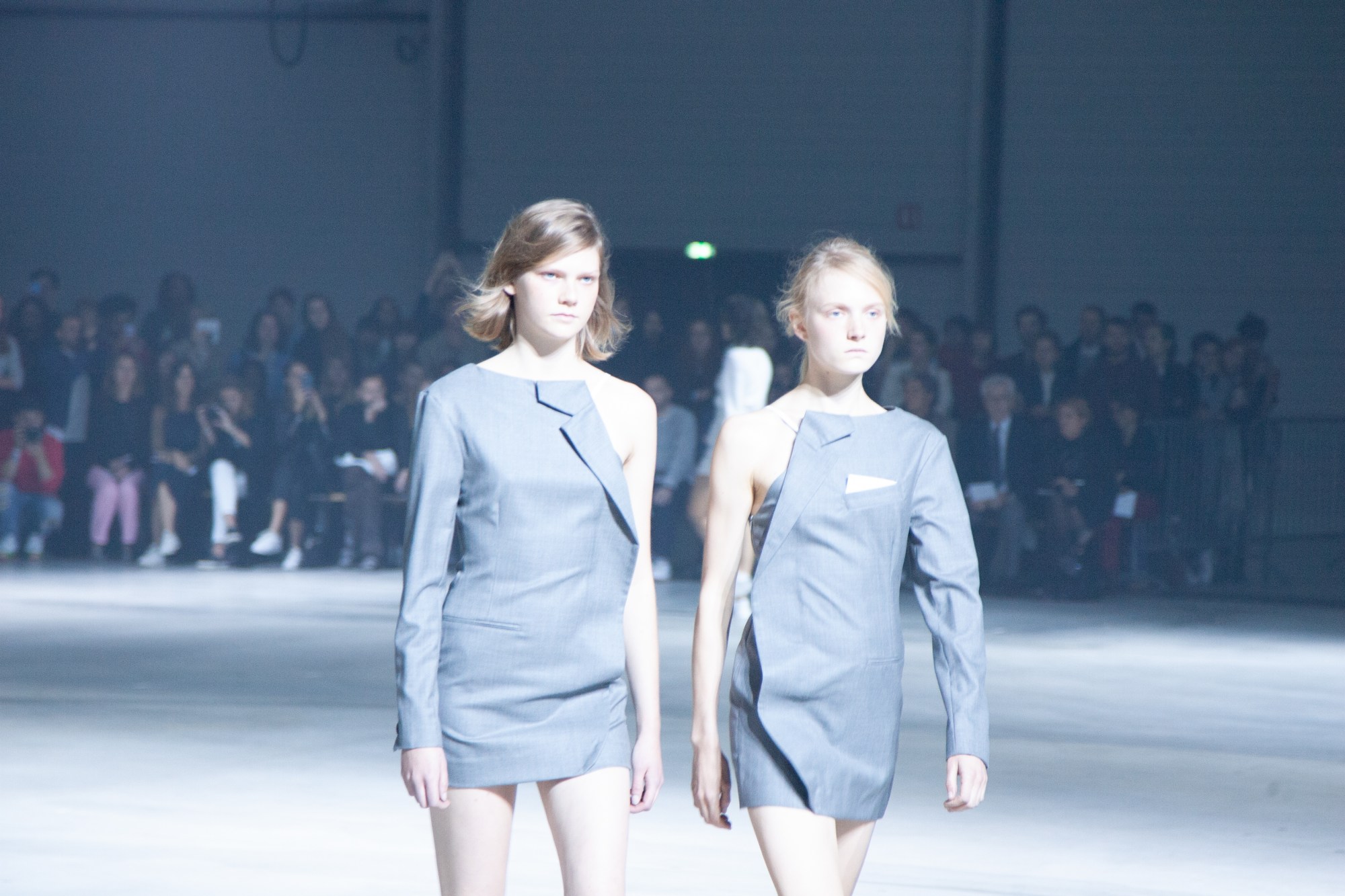 twins walking the gucci runway in matching spliced gray suit dresses