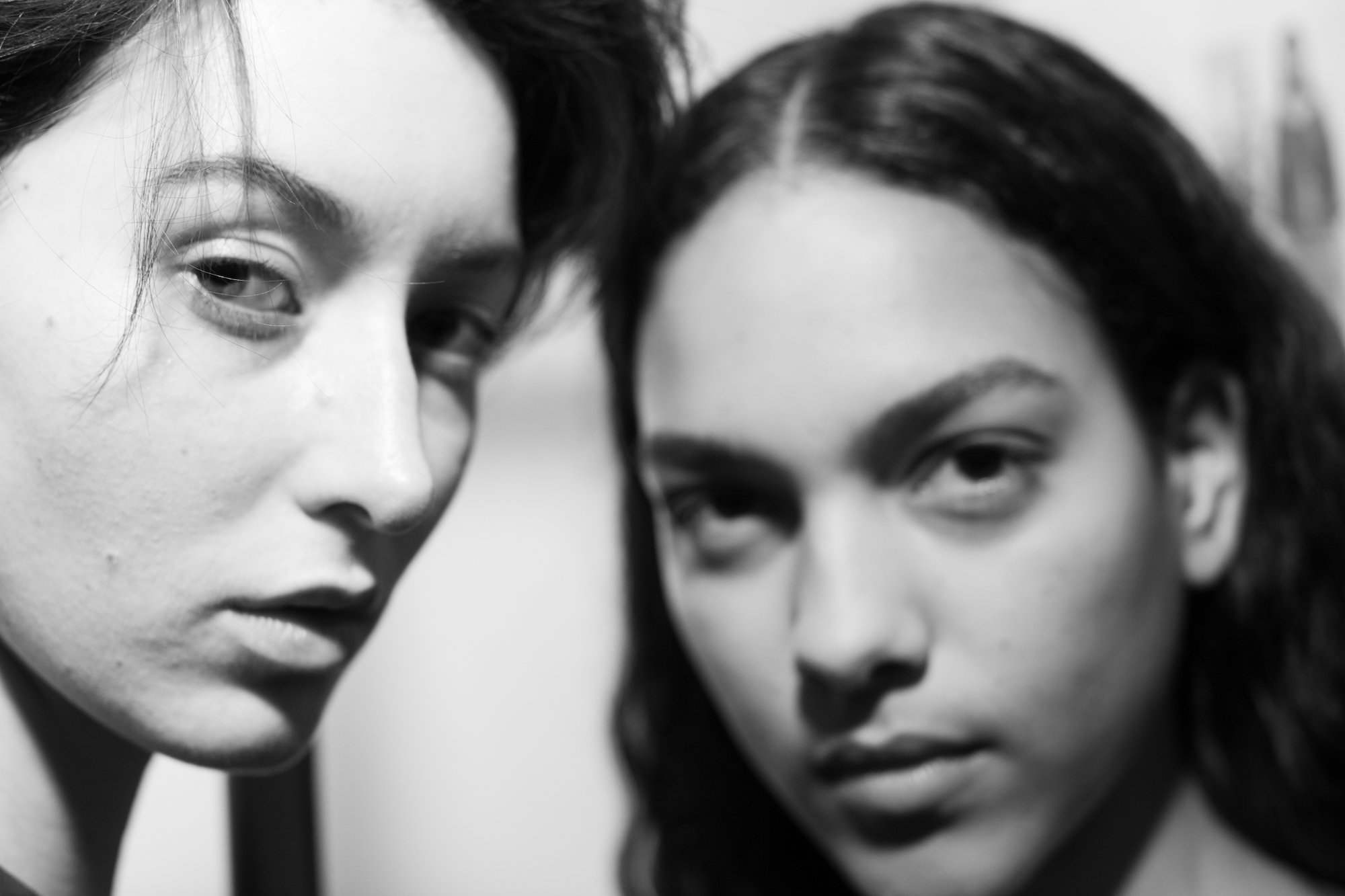 close up portrait of two models in black and white