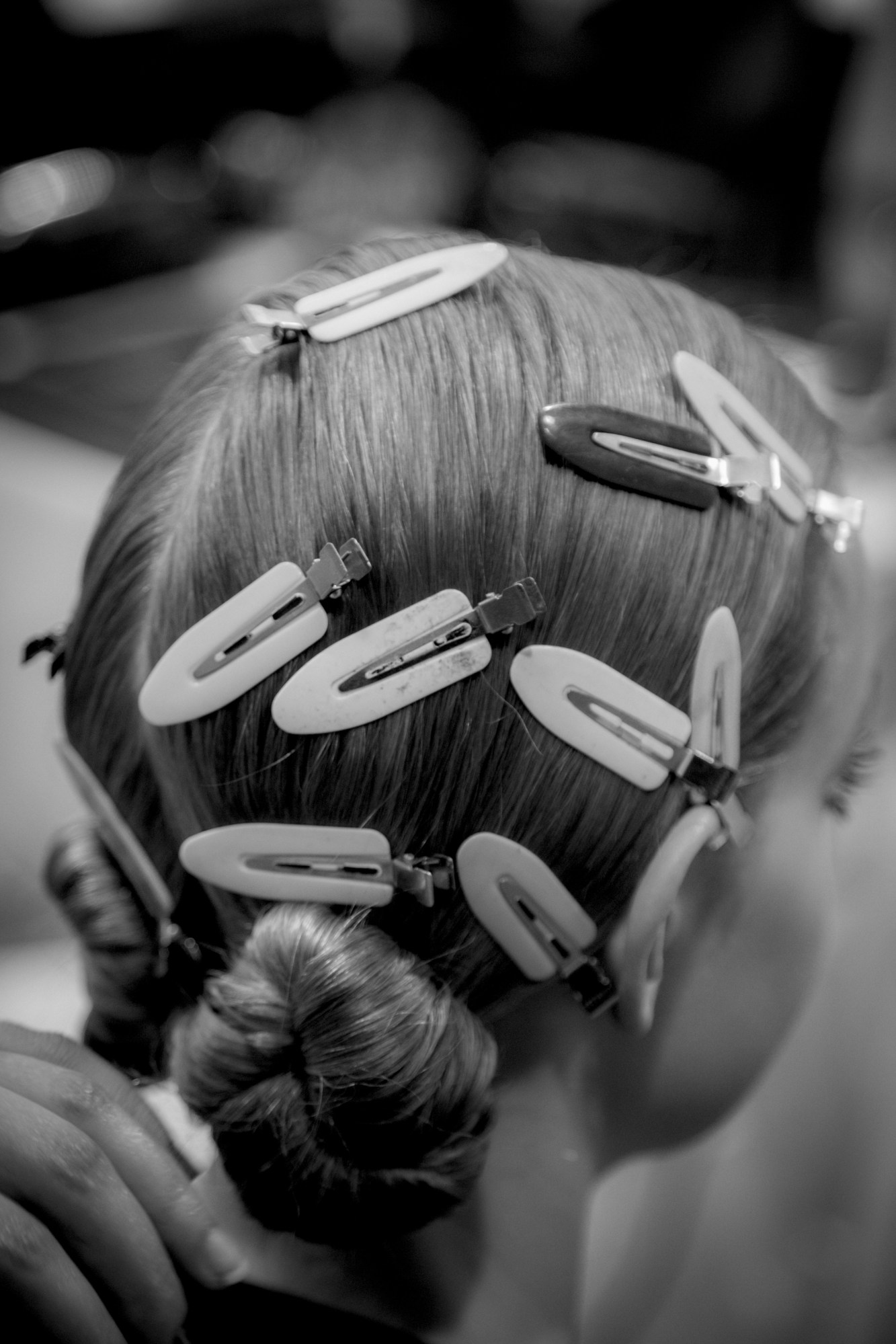 hair clips on a models head backstage at diro