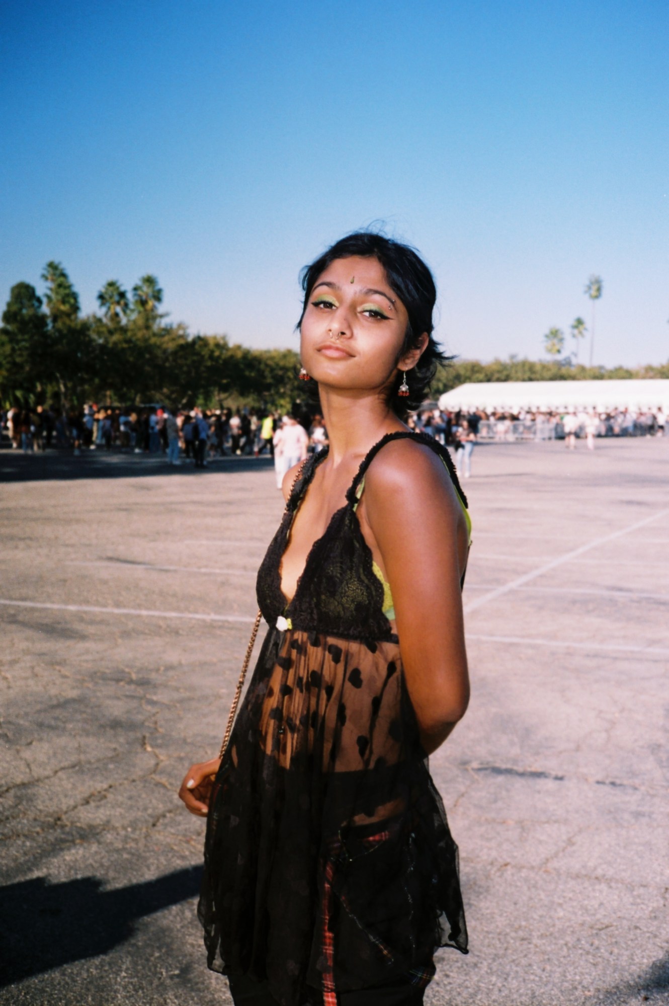 Nisha Venkat in a black lace heart top and green eye makeup photographed by miriam marlene