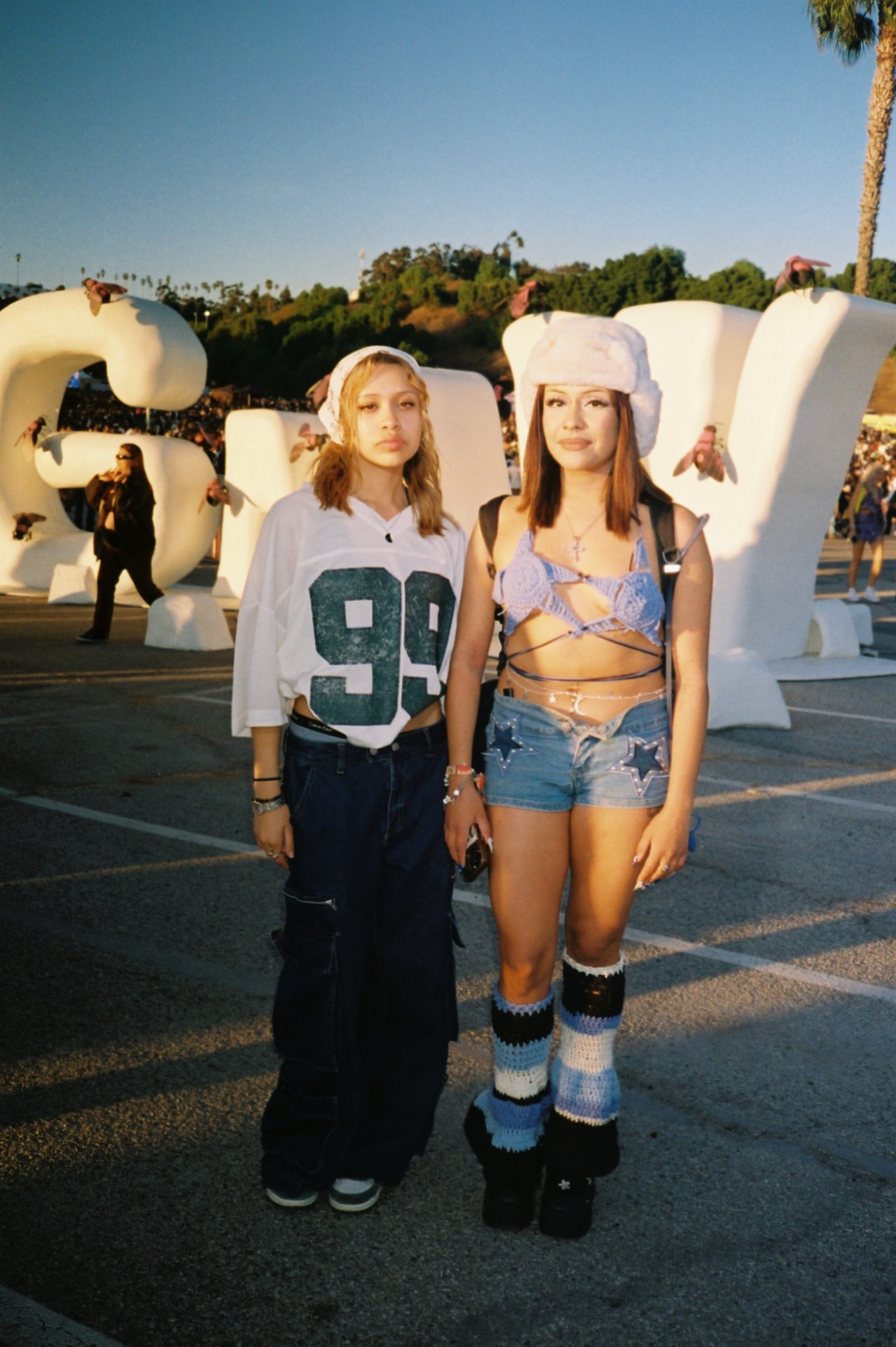 two girls posing in festival outfits in los angeles