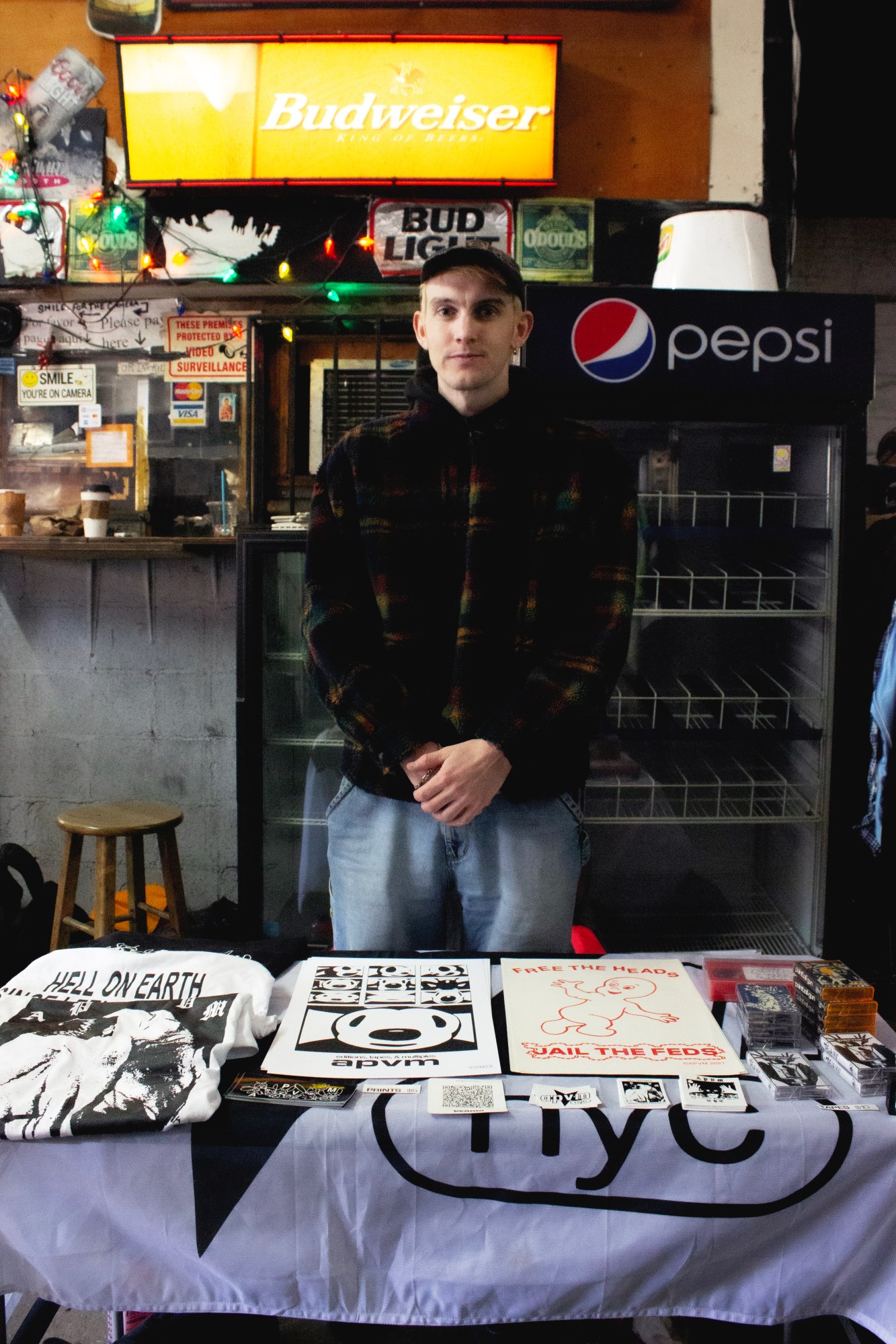 parker standing behind a table with screenprinted posted and tshirts