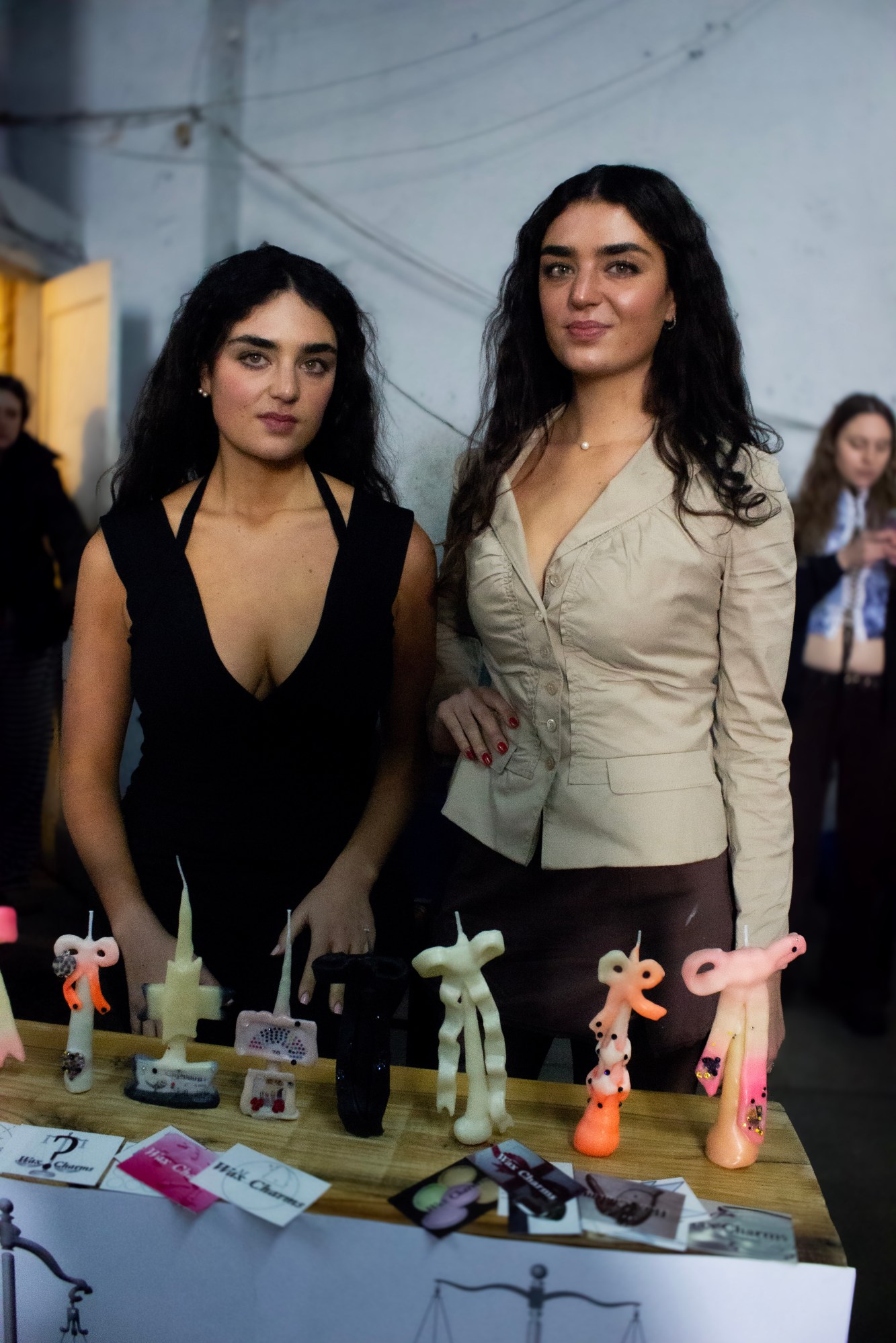 lara and sofia of waxcharms standing with their custome bow candles at parkmart in bushwick