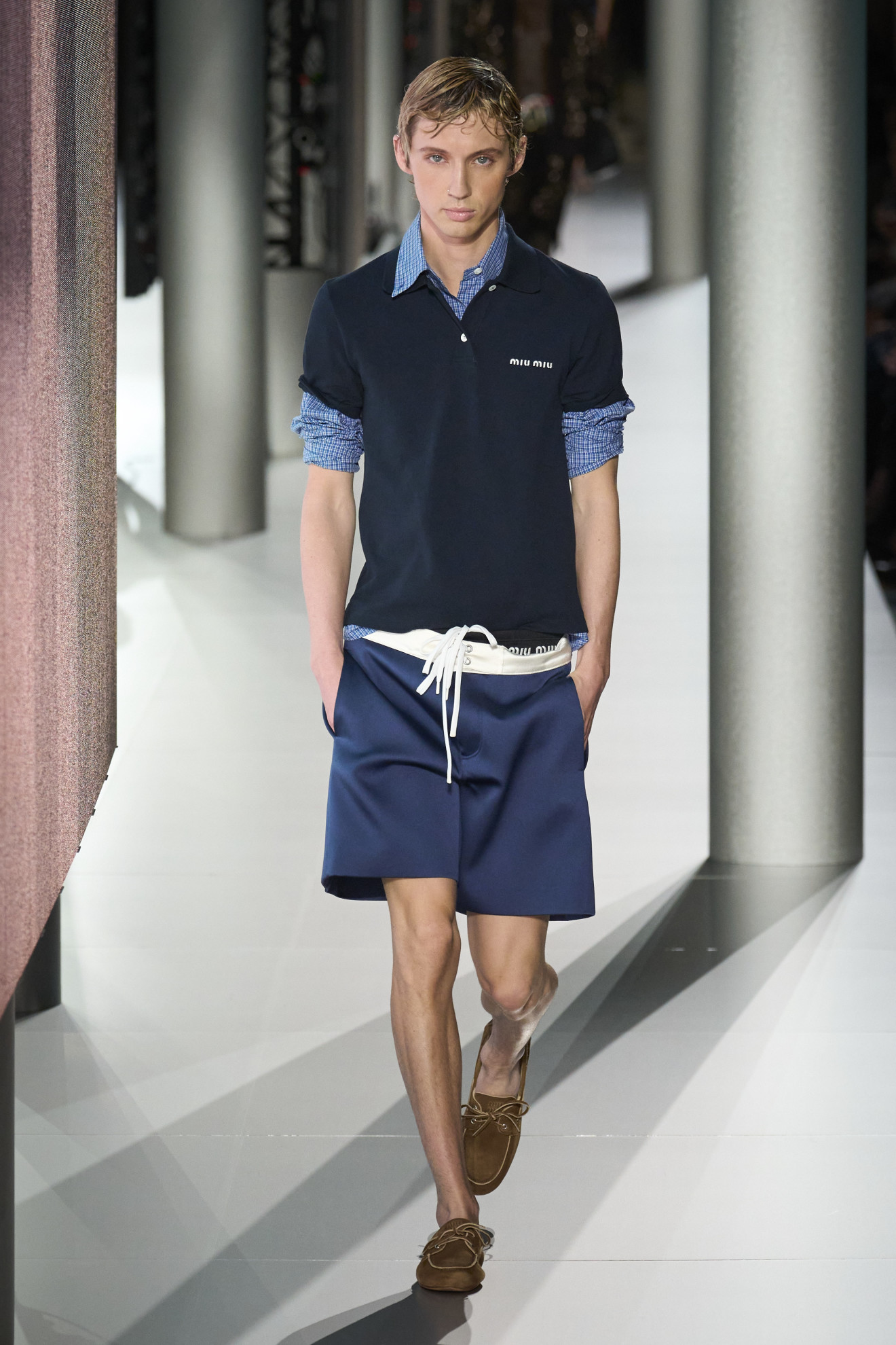 Troye Sivan wearing preppy style and boat shoes at the Miu Miu SS24 show