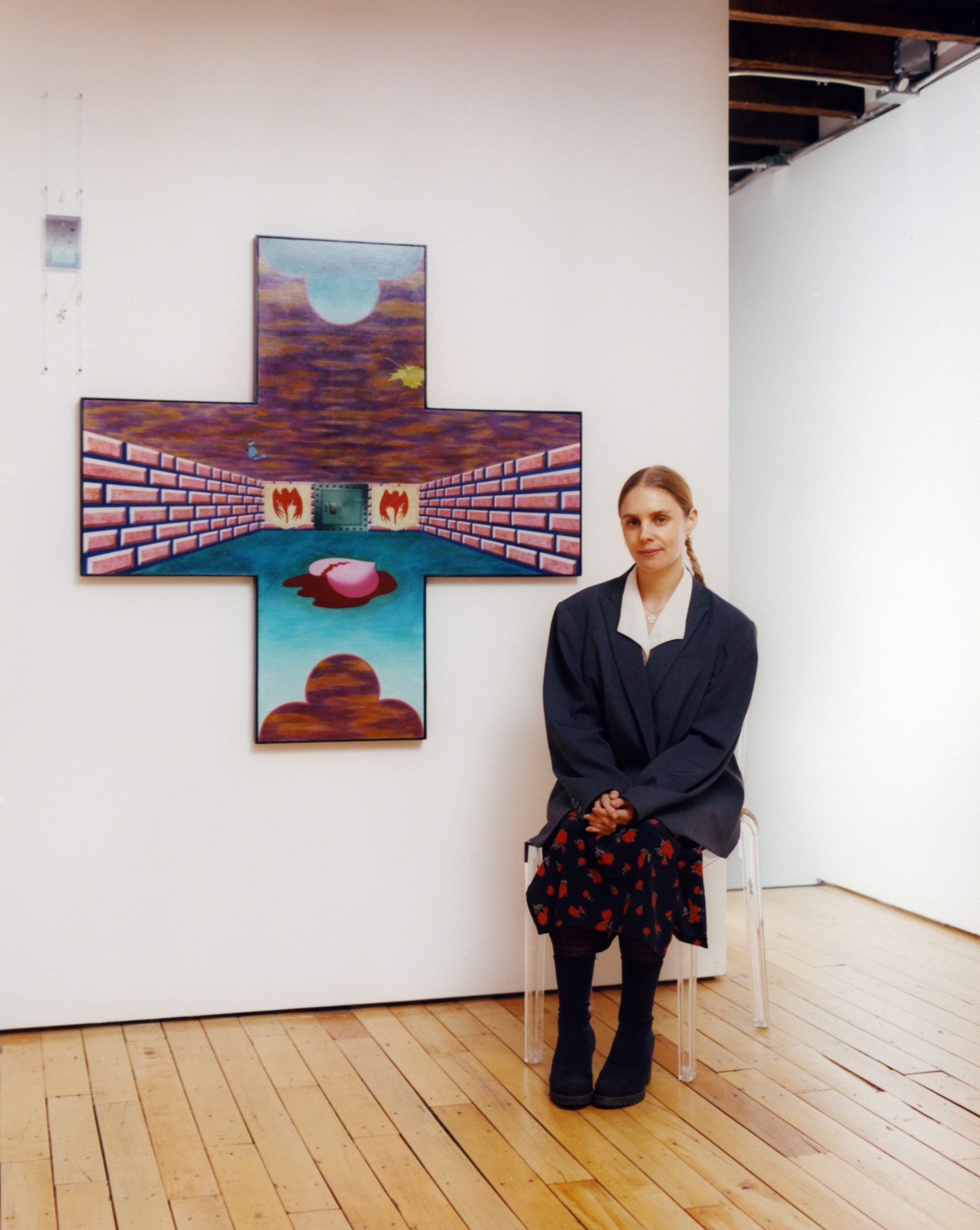 artist gitte maria moller sitting beside her work in a new york gallery by ashley markle