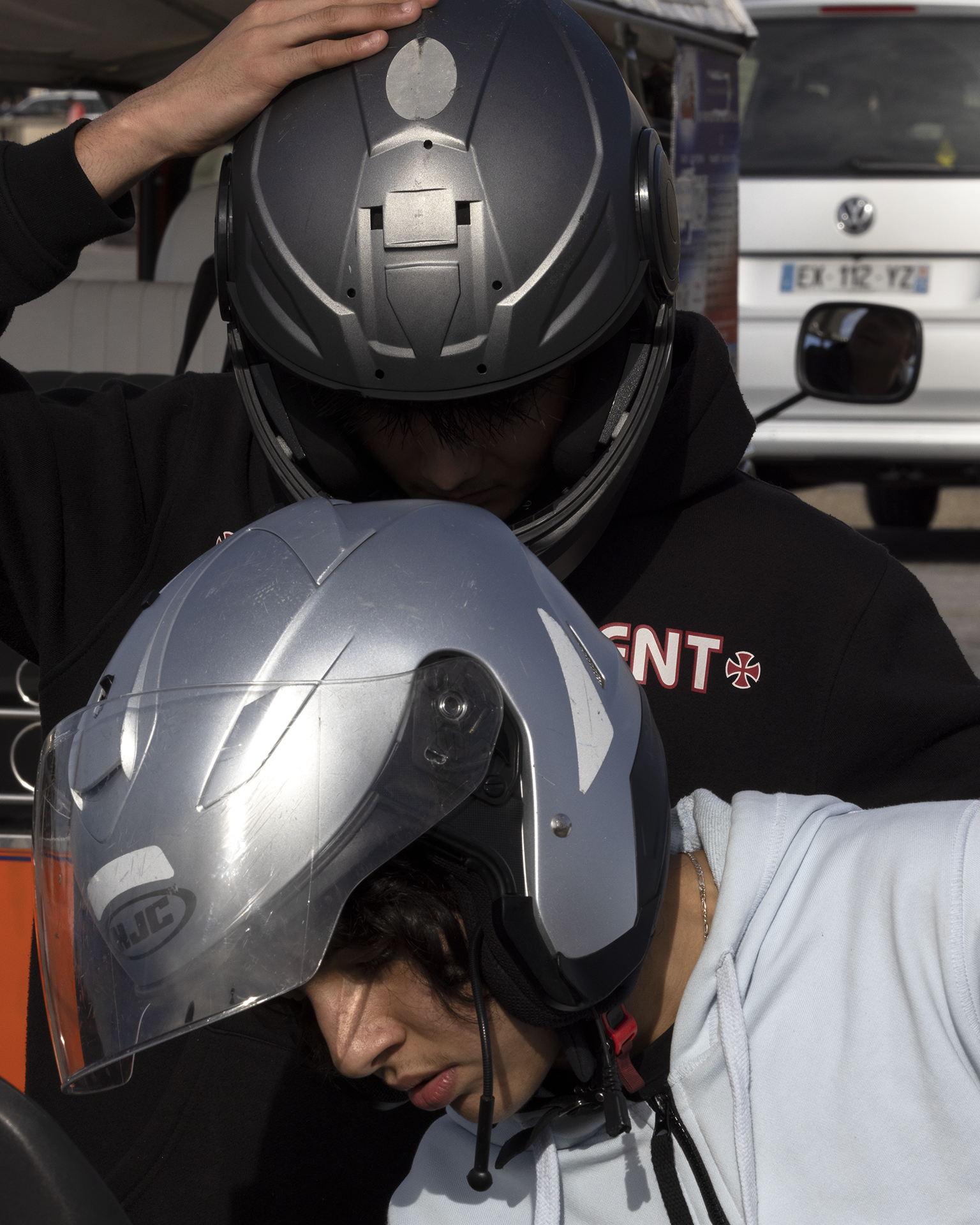 two boys wearing motorcycle helmets