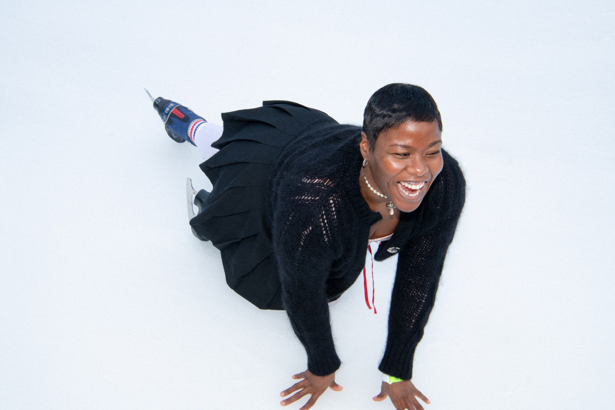 the artist precious okoyomon falls over laughing while skating on a rink