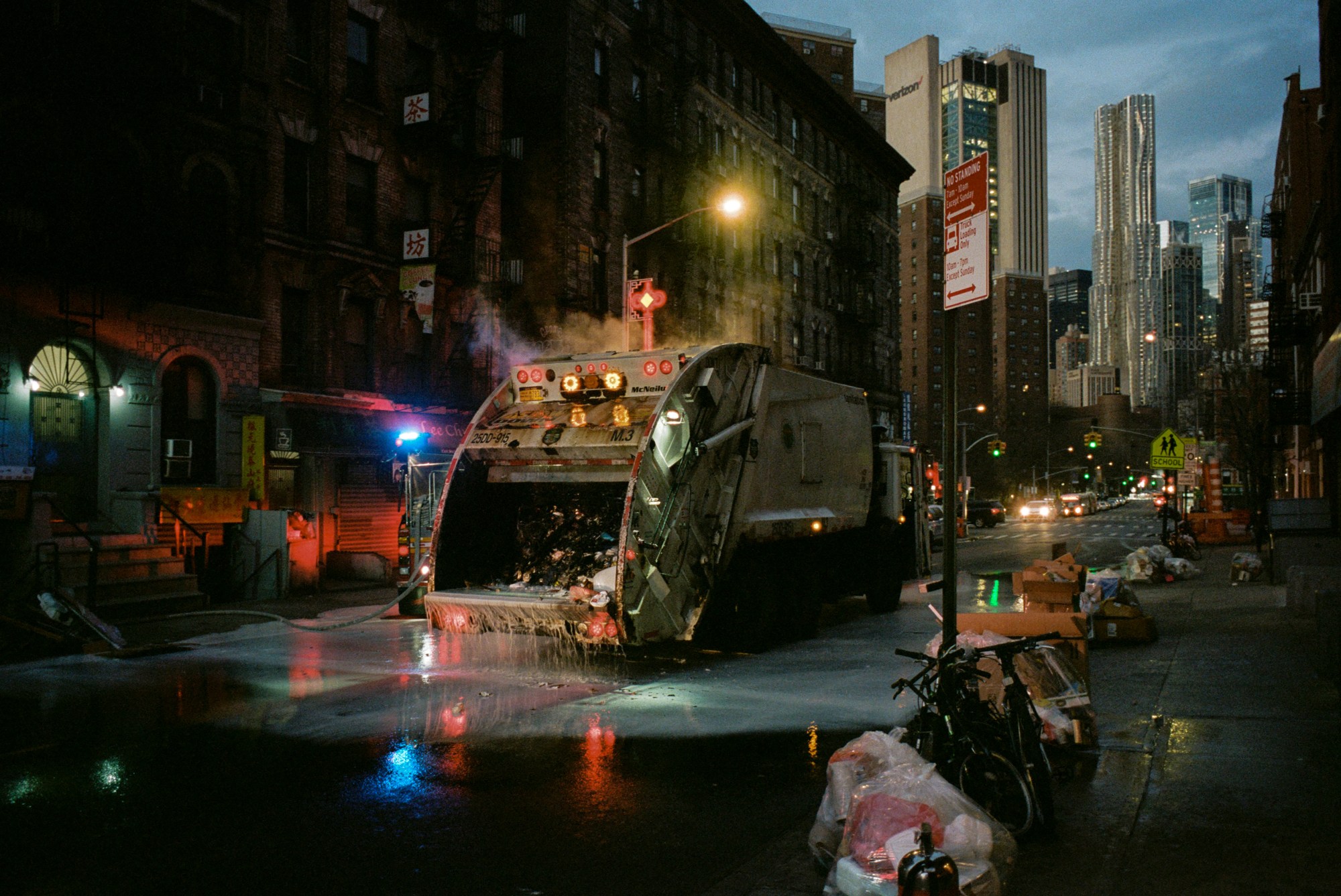 a garbage truck in new york's madison street is covered in water having been extinguished following a fire