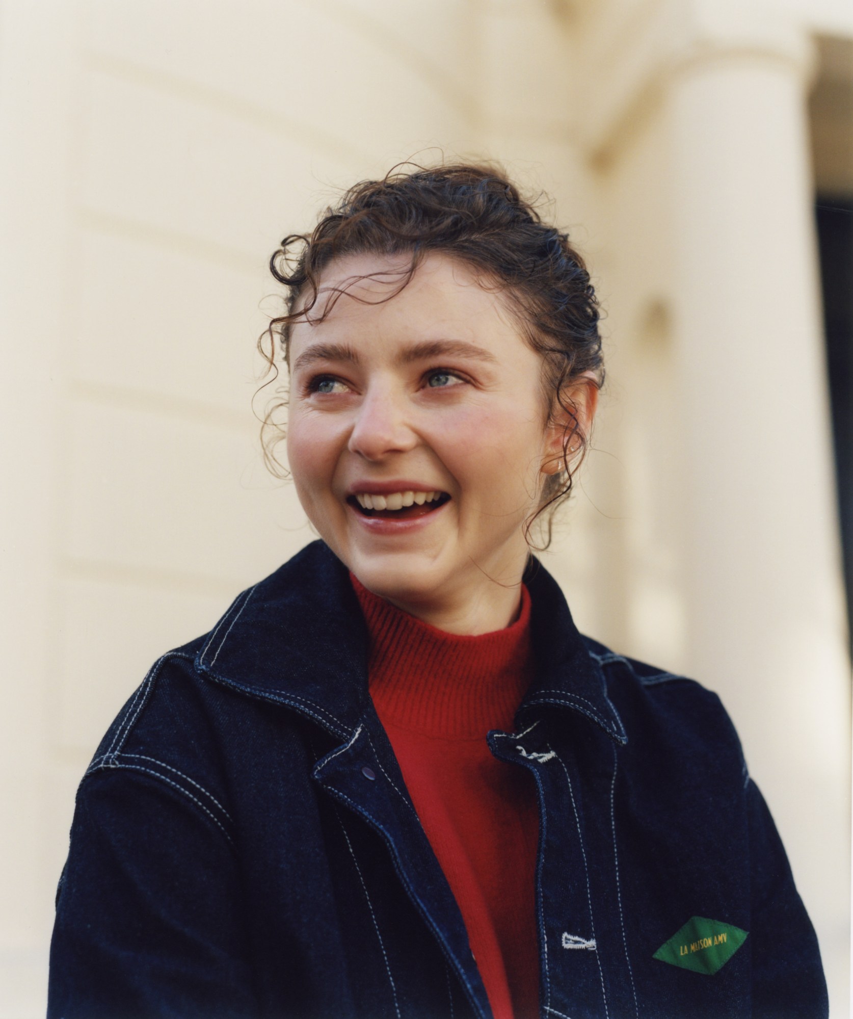 thomasin mckenzie looking off and laughing outside