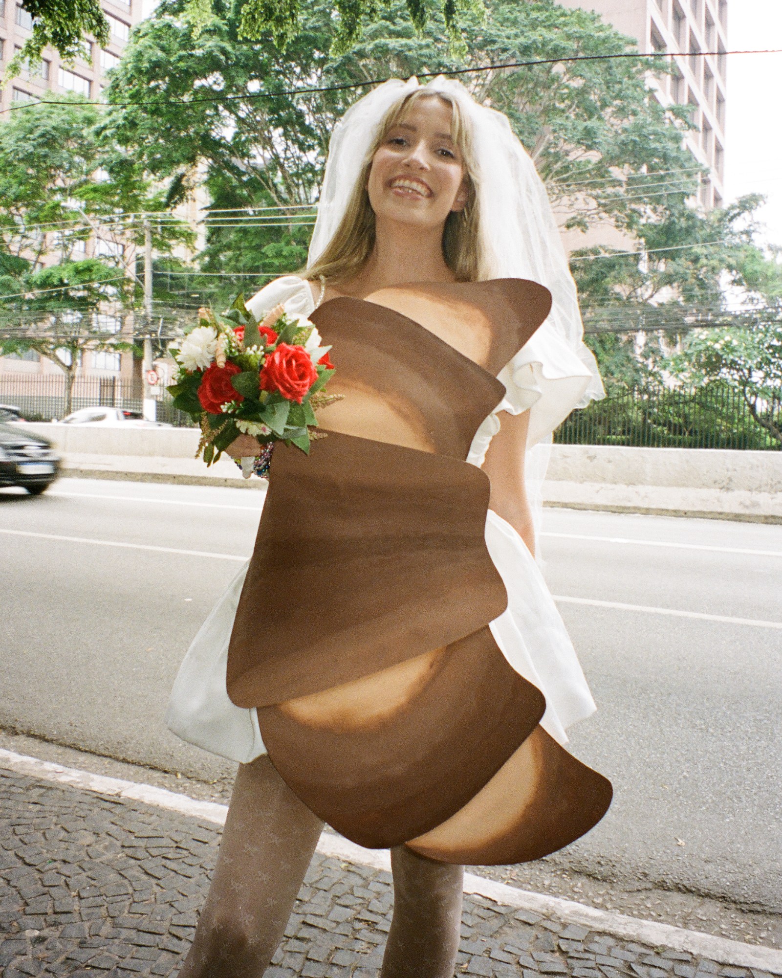 Photograph by Pedro Pinho of a Taylor Swift fan wearing a gown shaped like a pastry outfit inspired by Speak Now at the Eras Tour in Brazil