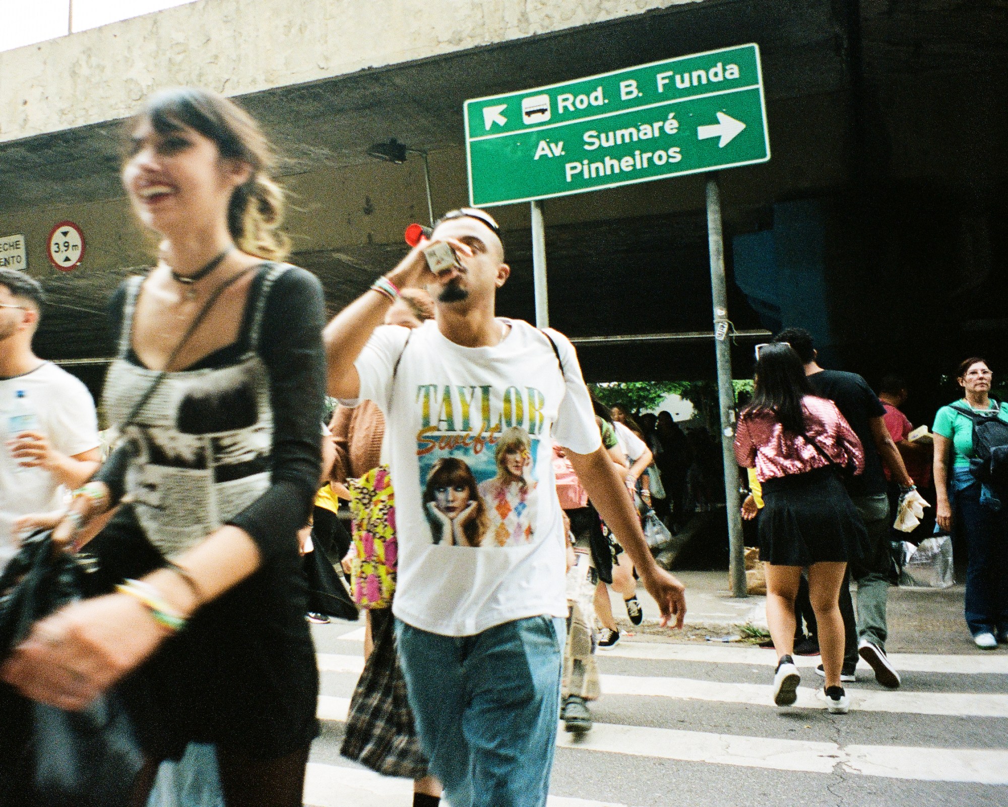 Photograph by Pedro Pinho of Taylor Swift fans crossing the road to see her at the Eras Tour concerts in Brazil