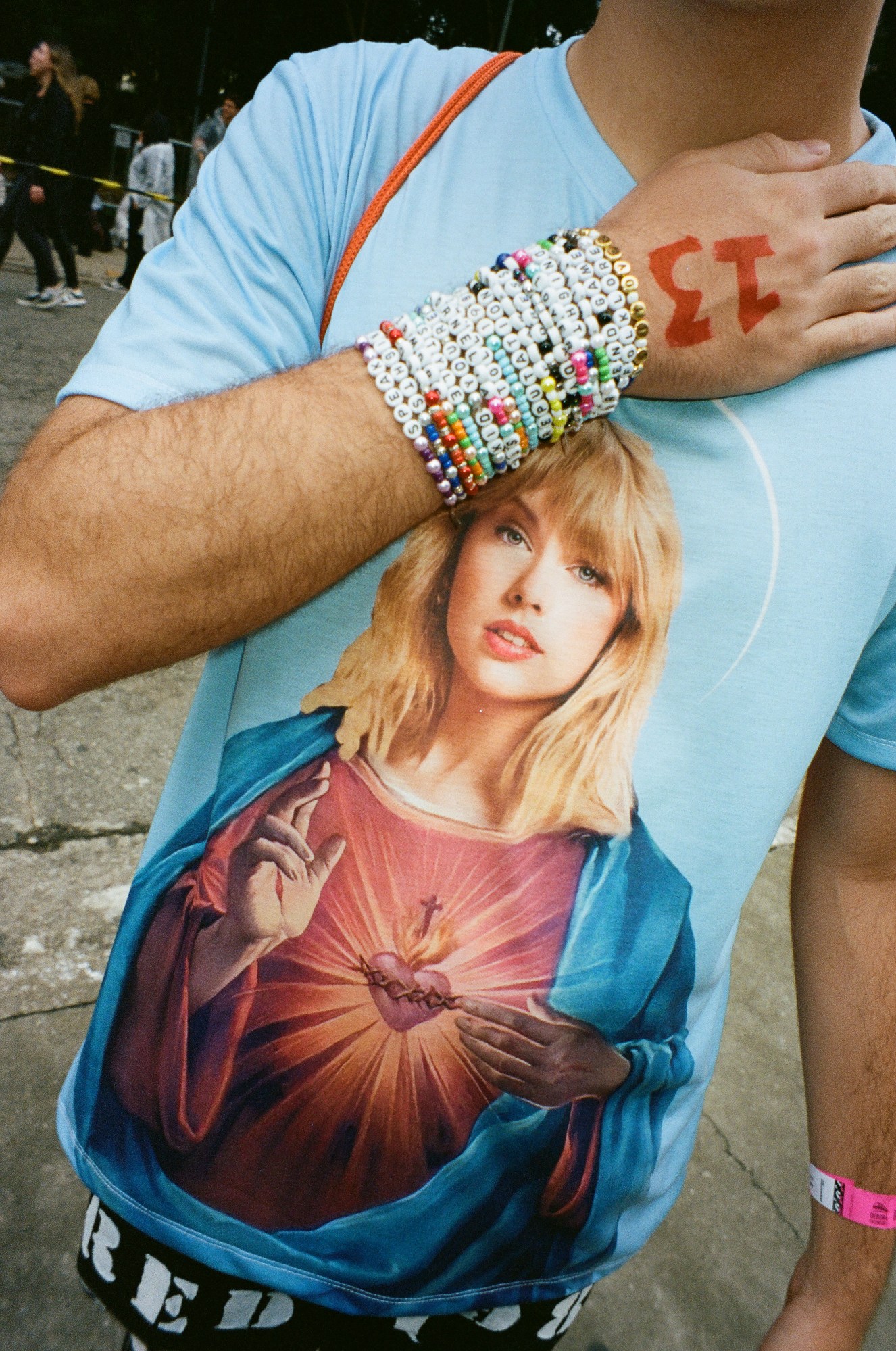 Photograph by Pedro Pinho of a Taylor Swift fan wearing a t-shirt with Taylor as Jesus at the Eras Tour in Brazil