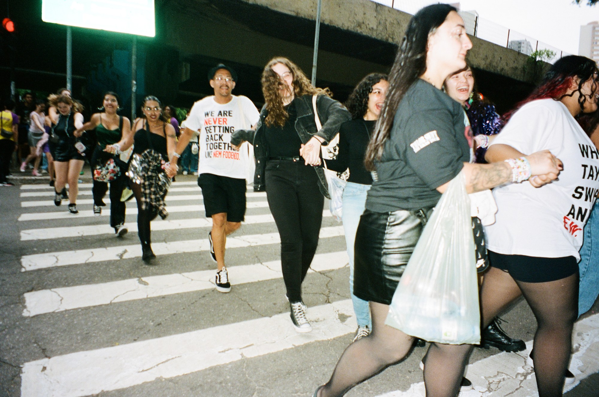 Photograph by Pedro Pinho of Taylor Swift fans crossing the road to see the Eras Tour in Brazil