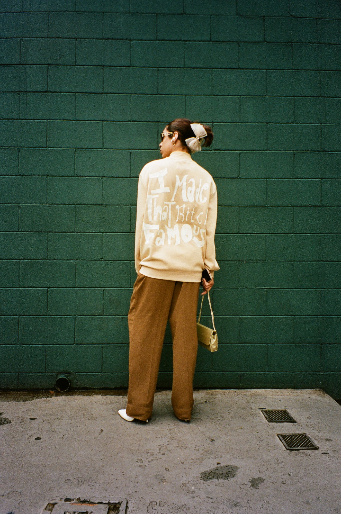 Photograph by Pedro Pinho of a Taylor Swift fan wearing an I made that bitch famous Kanye lyric jacket at the Eras Tour in Brazil