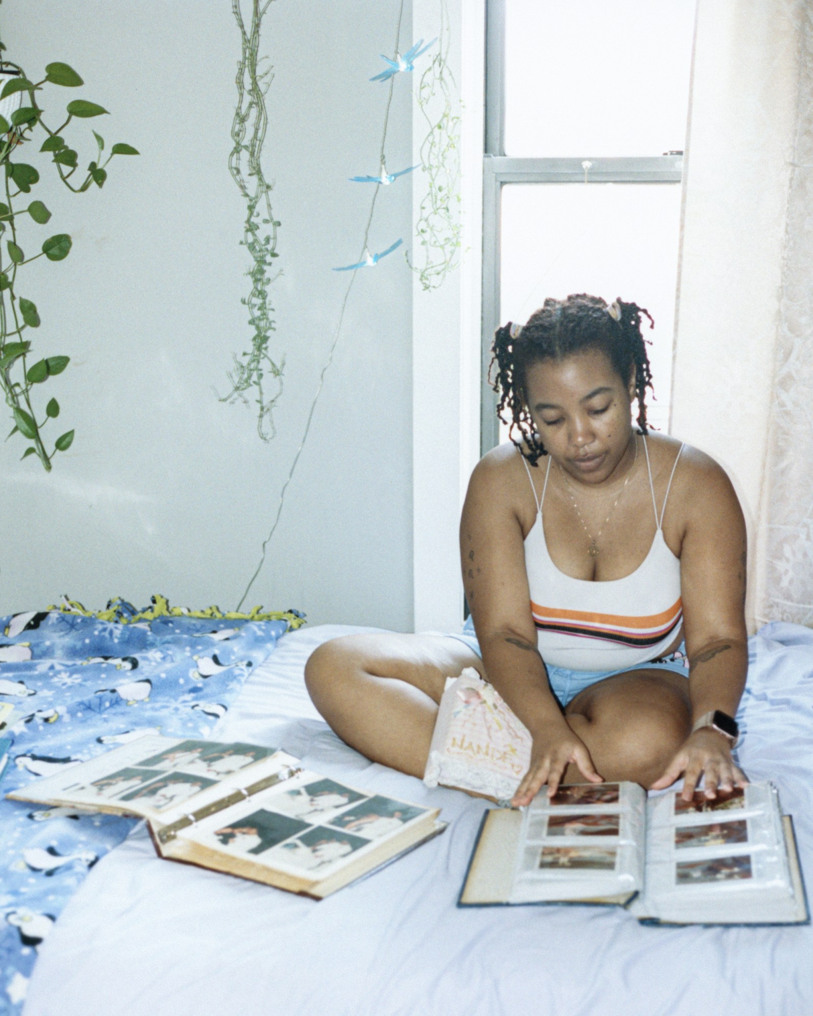 nande walters looking at photo albums in her bed