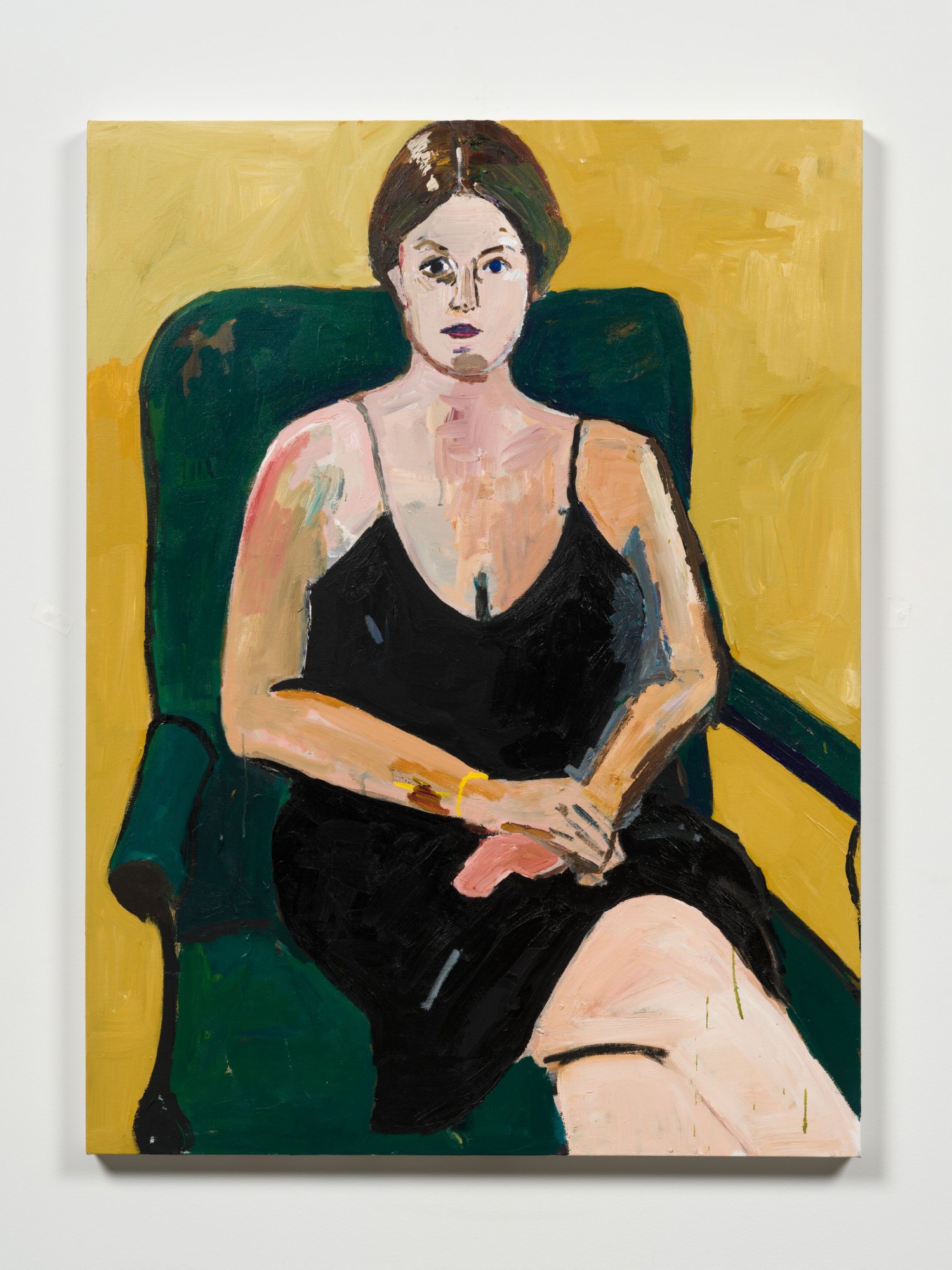 a woman in a black dress in a green chair