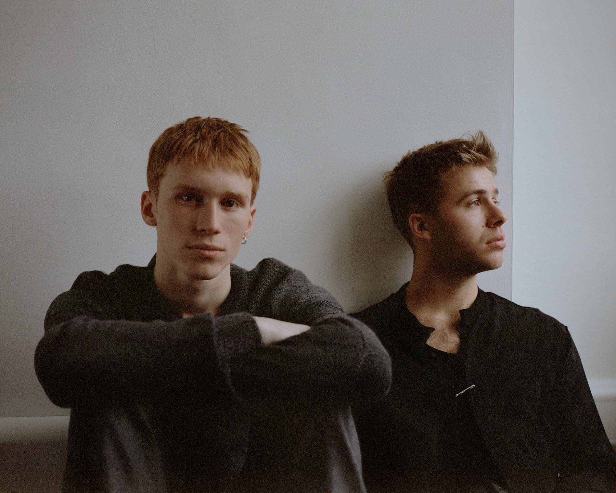 luther ford and ed mcvey actors sittting on the floor against a white wall