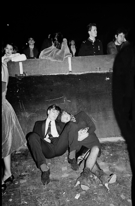 Photograph by Virginia Turbett of two people asleep against a ramp at a venue in The chaotic birth of 70s British subculture