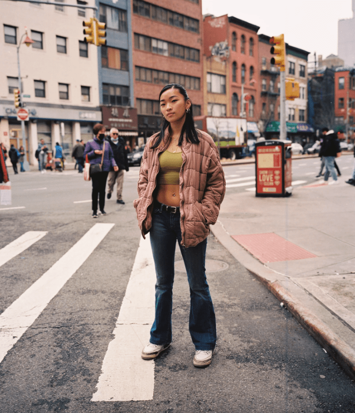 Photograph by Gabriel Chiu of a woman stood at a crossing in Chinatown in New York