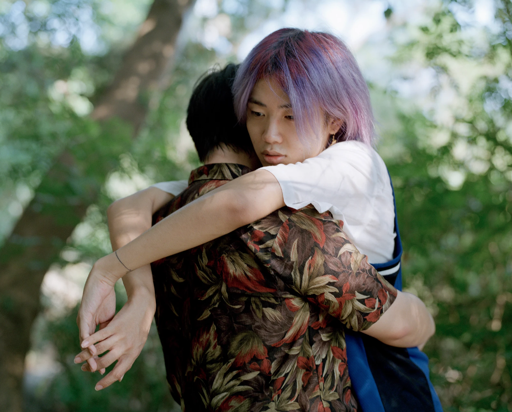 Photograph by Sarah Mei Herman of two people hugging under a tree from Solace