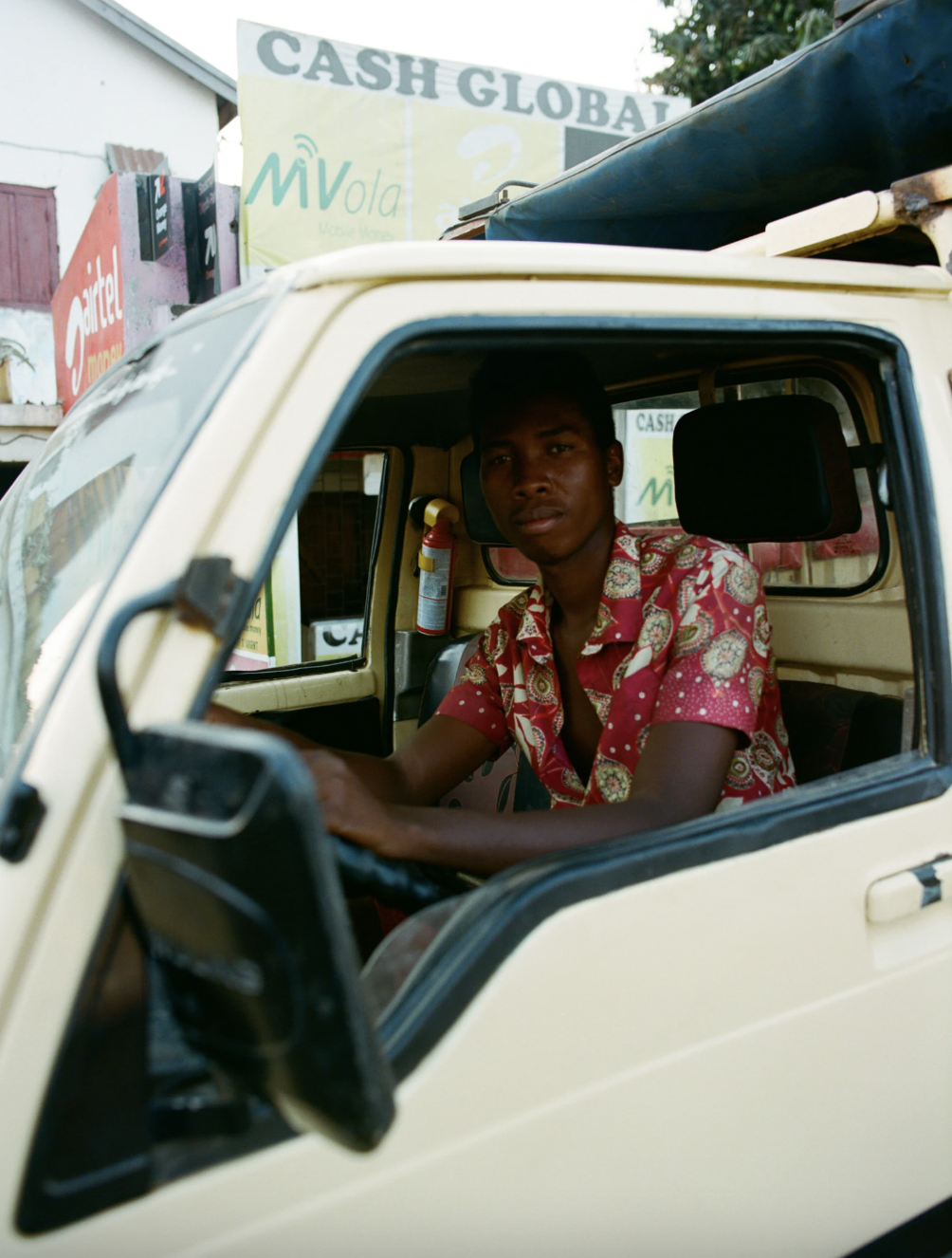 Photograph by Ivory Campbell of a man sat in a van in Madagascar